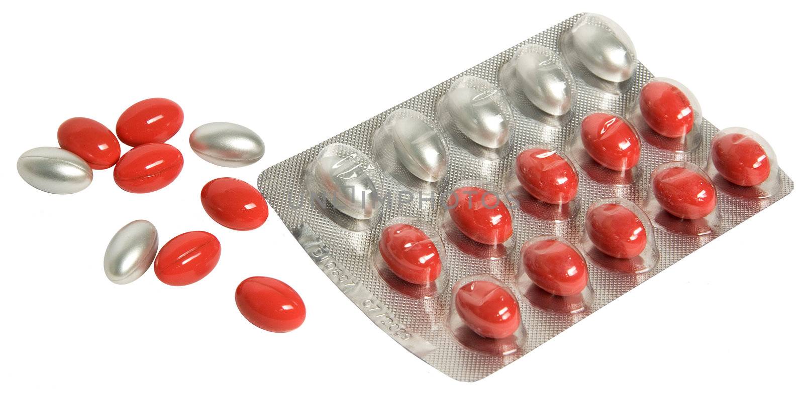 Red and silver capsules on a white background by nutly