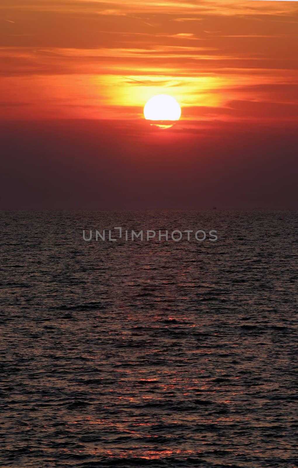 Sun setting over the sea with clouds