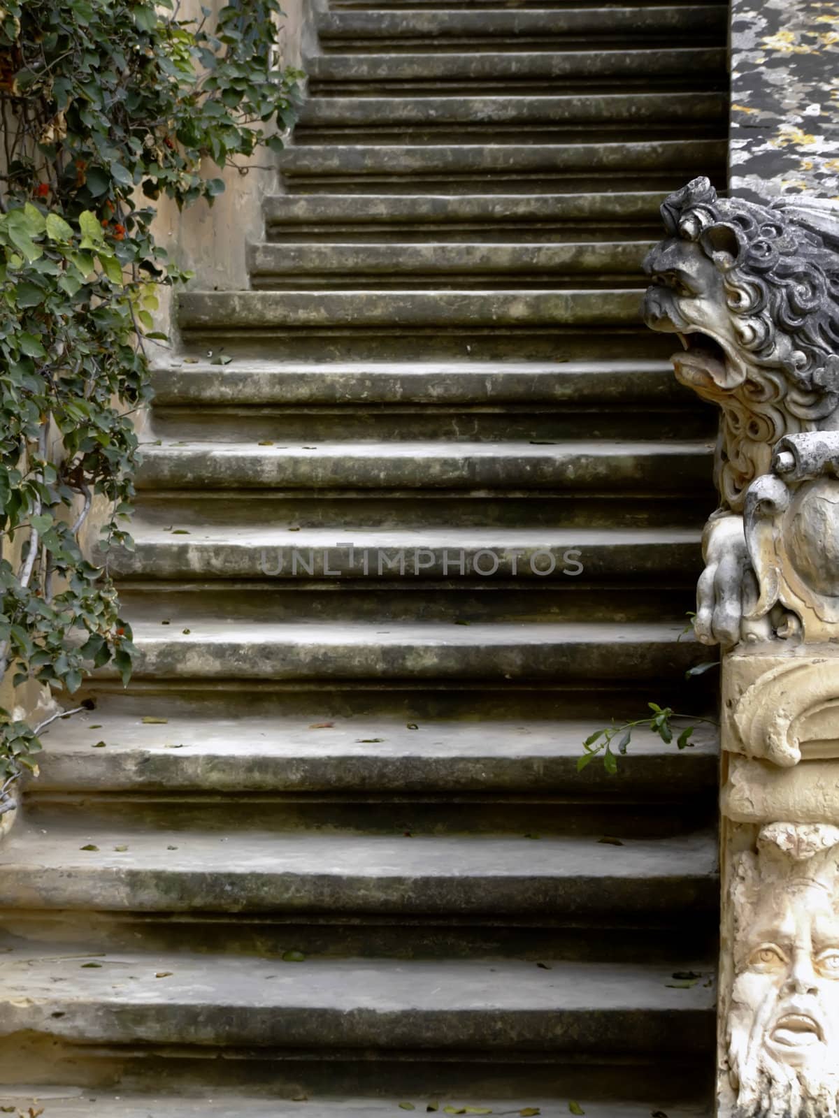 Imposing medieval stone sculpture of lion, guarding palace staircase.