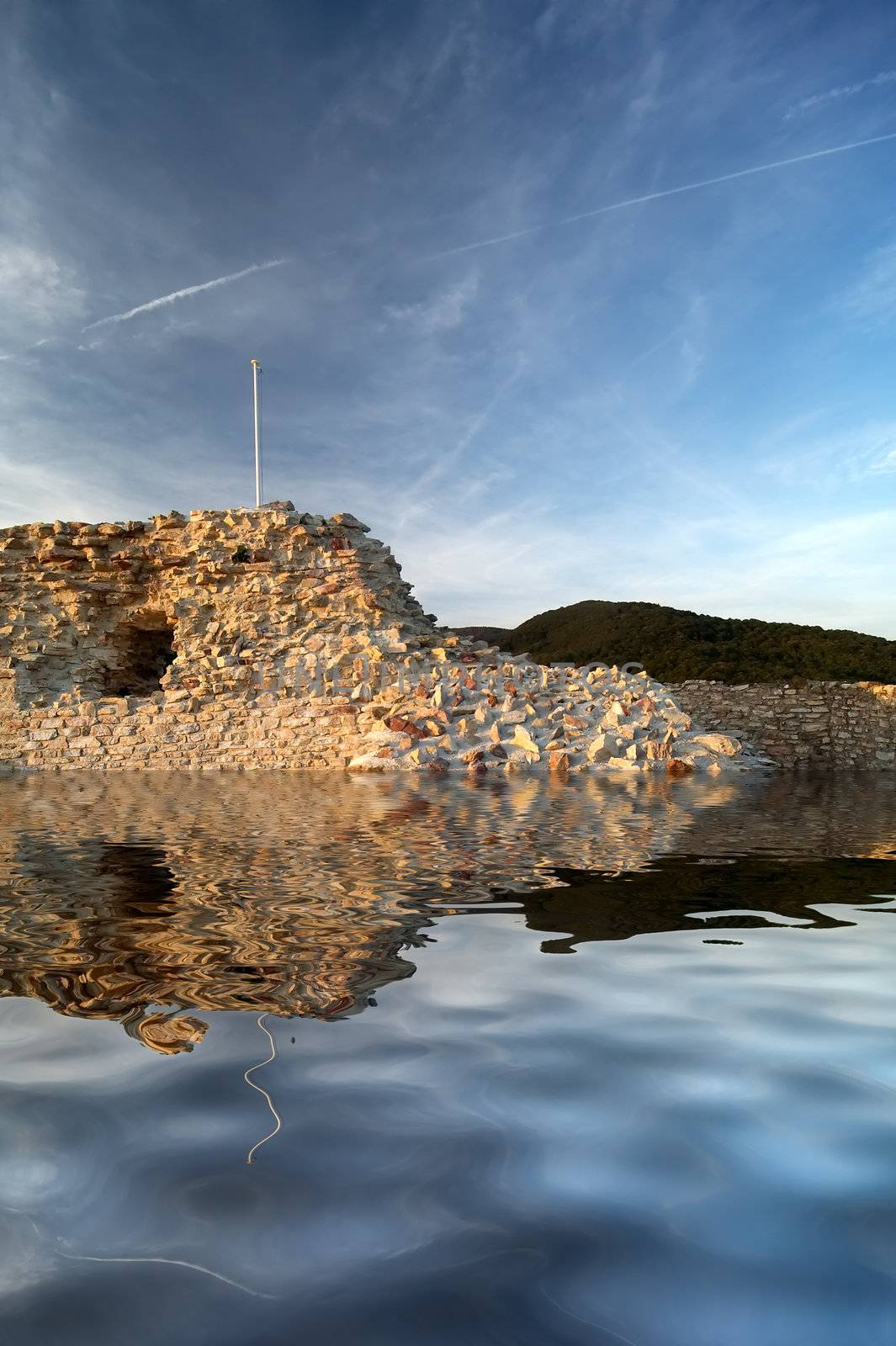 Stone wall with reflection in water