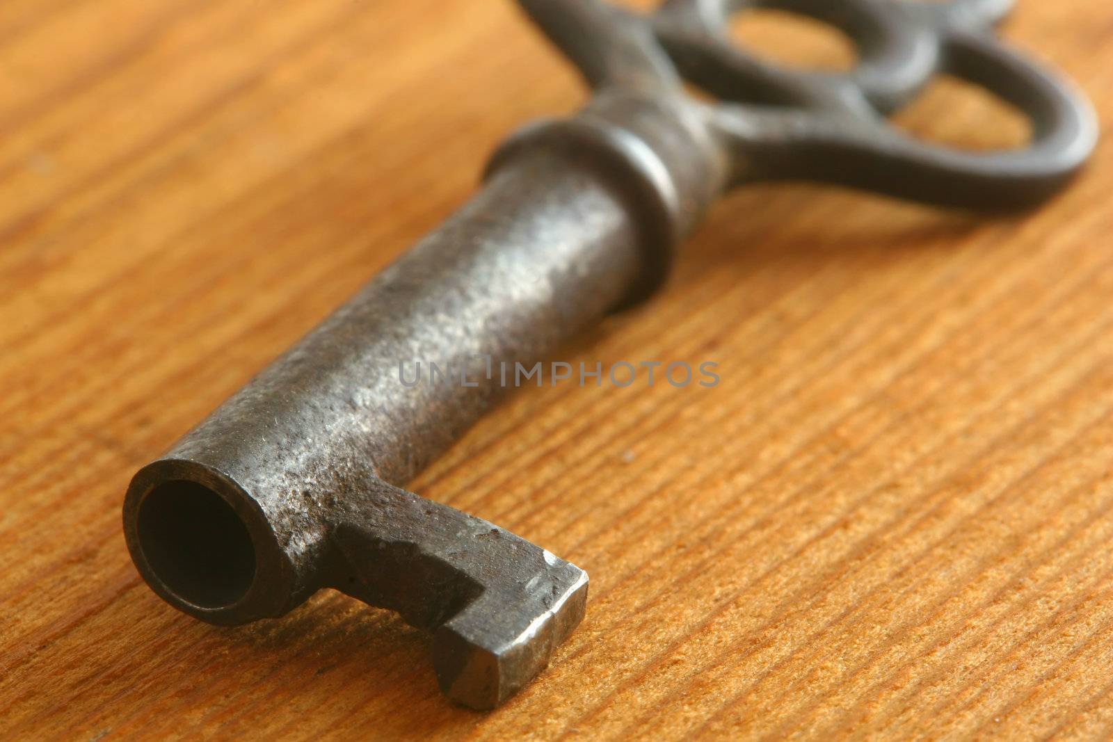 Old key on wood background.