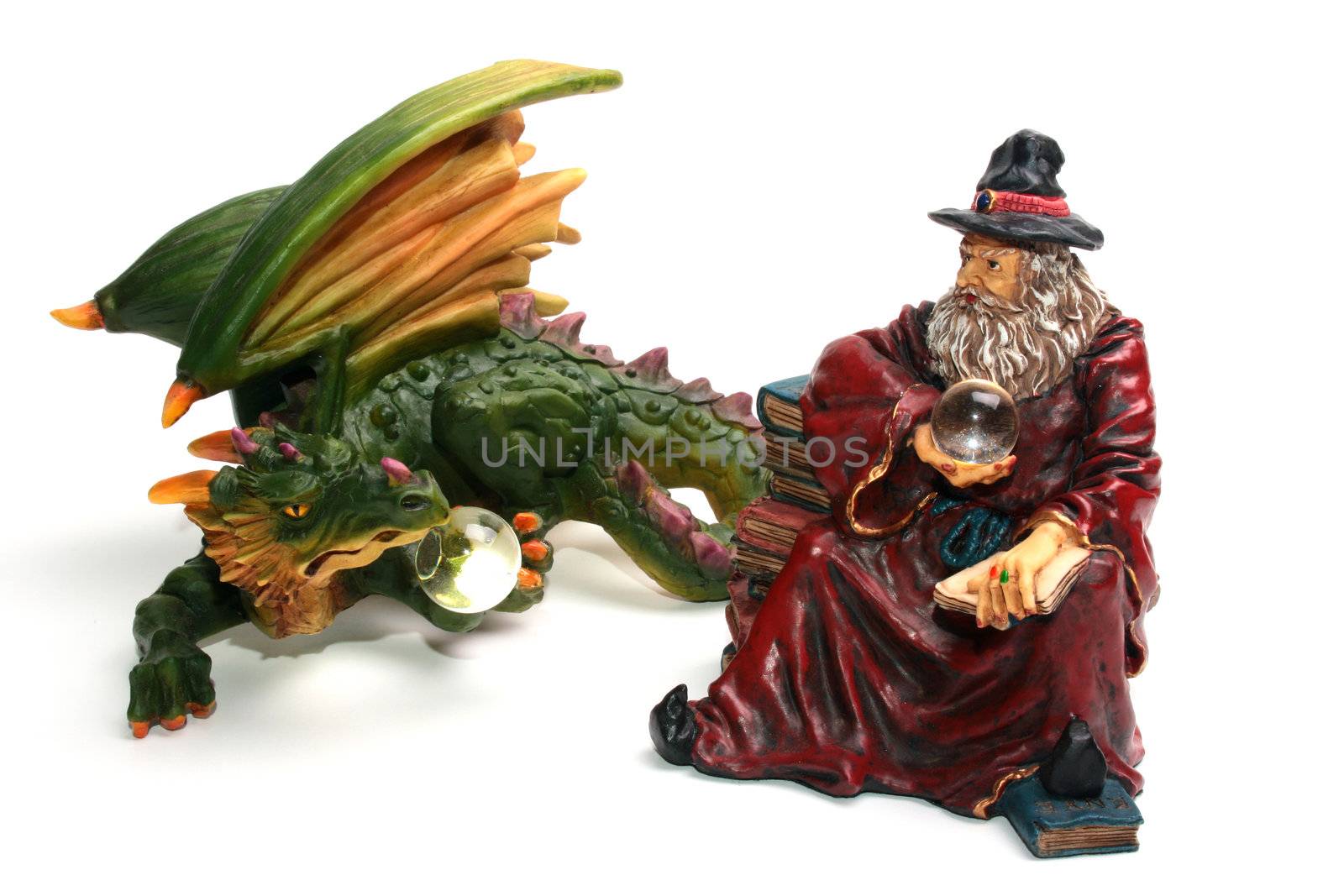 Ceramic figures of a dragon and the wizard on a white background.