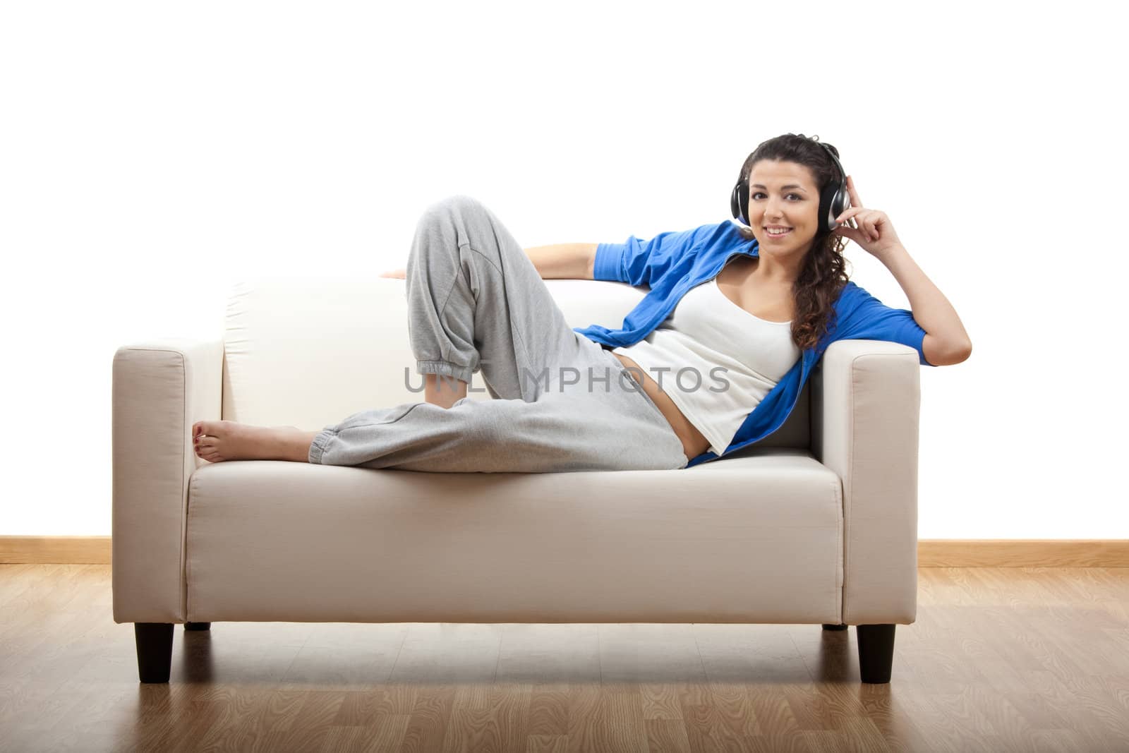 Portrait of a girl lying on the couch and making a phone call