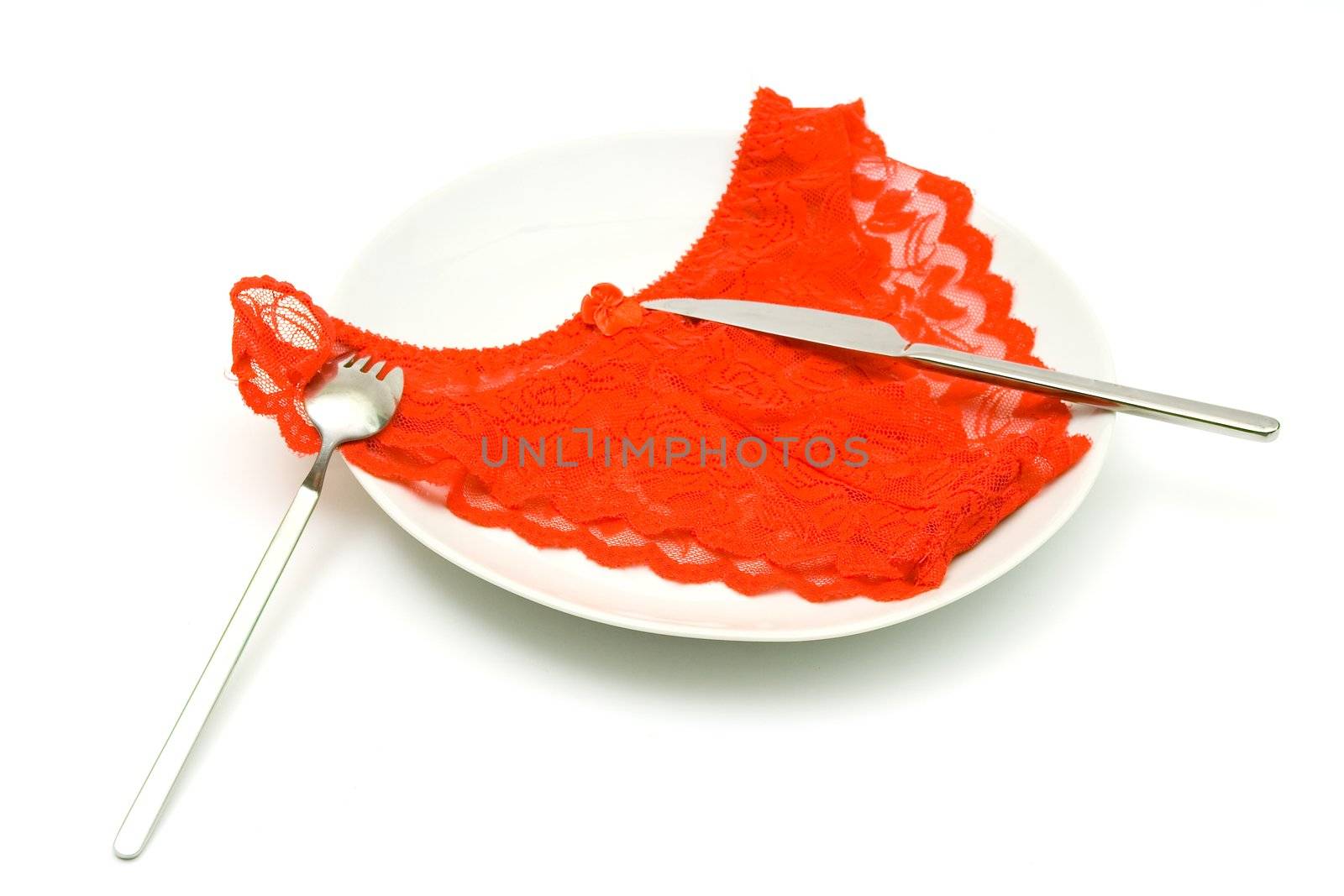 Red Women's elegant and sexy panties, lying on a white dish