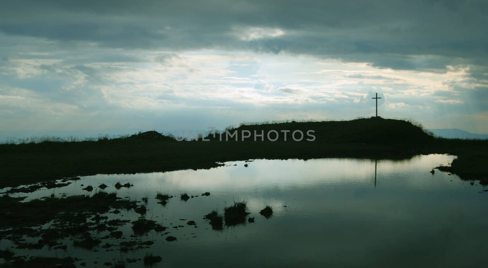 Cross above the lake marked the high peak of the mountains