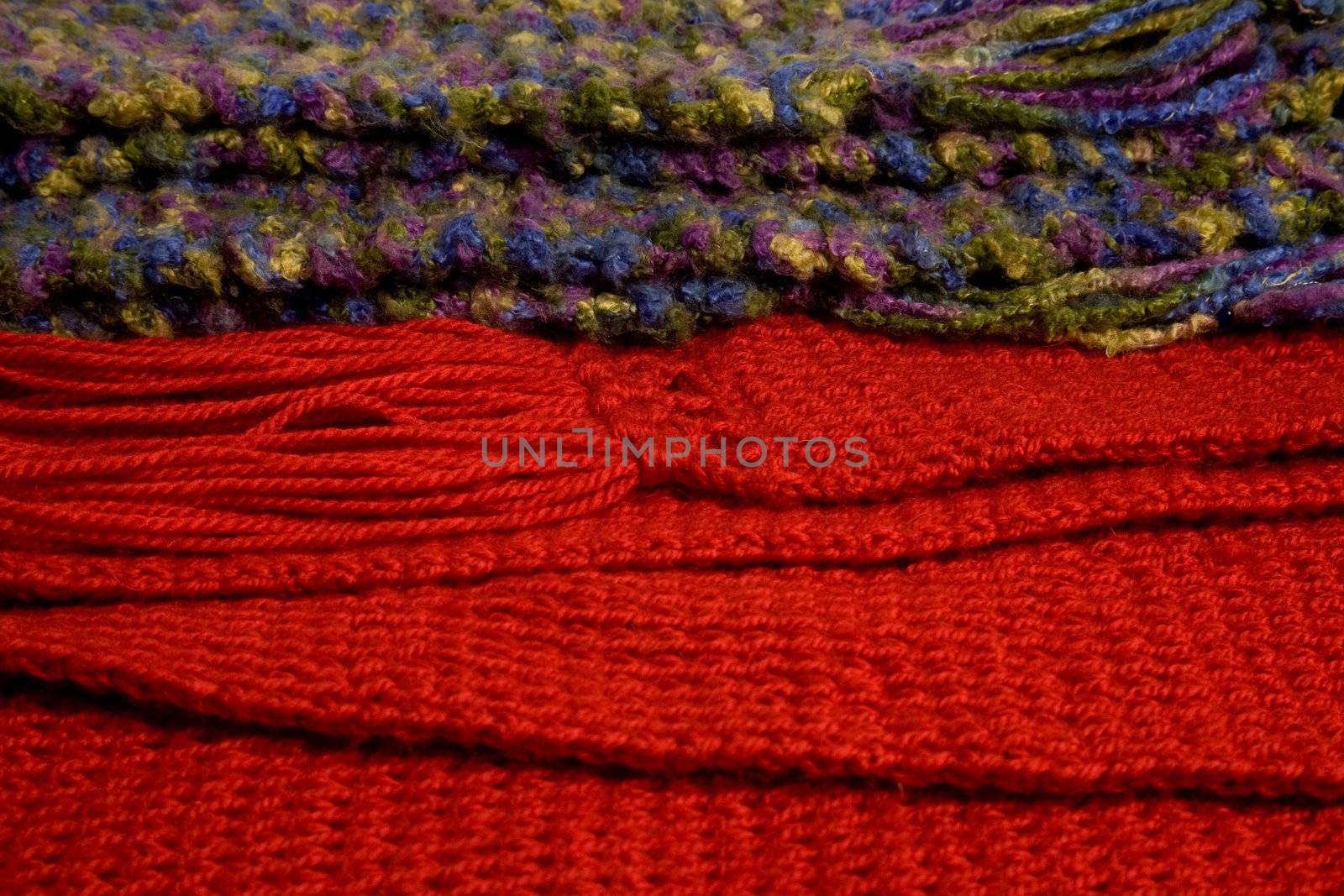 Close-up of two colorful wool scarfs