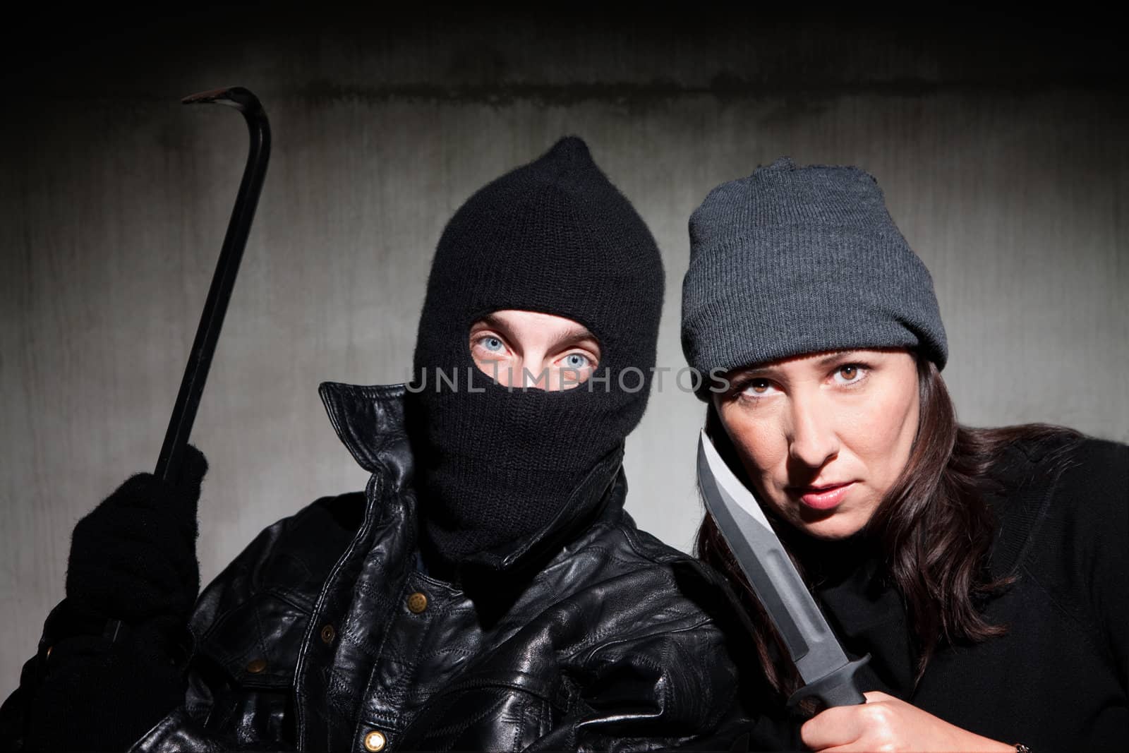Male and female criminals wielding dangerous weapons