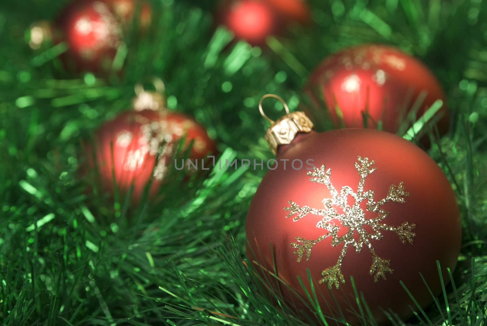 Red christmas balls on the green tinsel. aRGB.