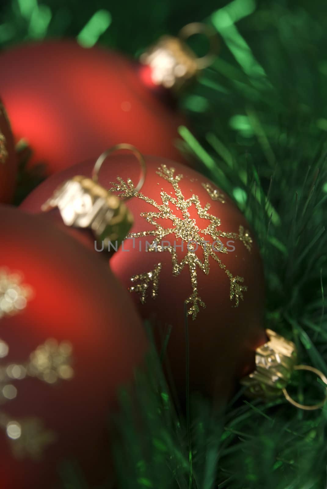 Red christmas balls on the green tinsel. aRGB.