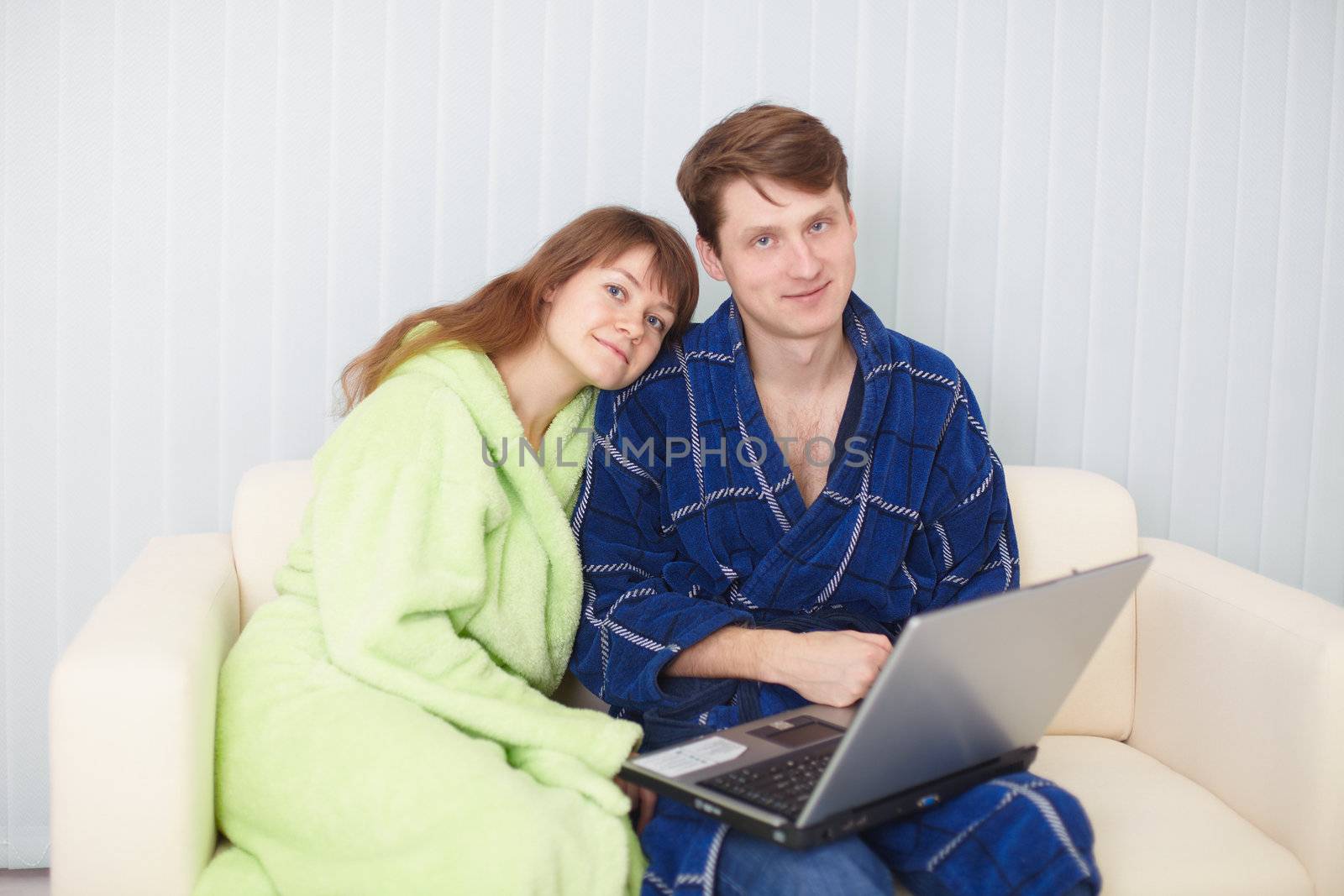 Young couple on a sofa with the laptop