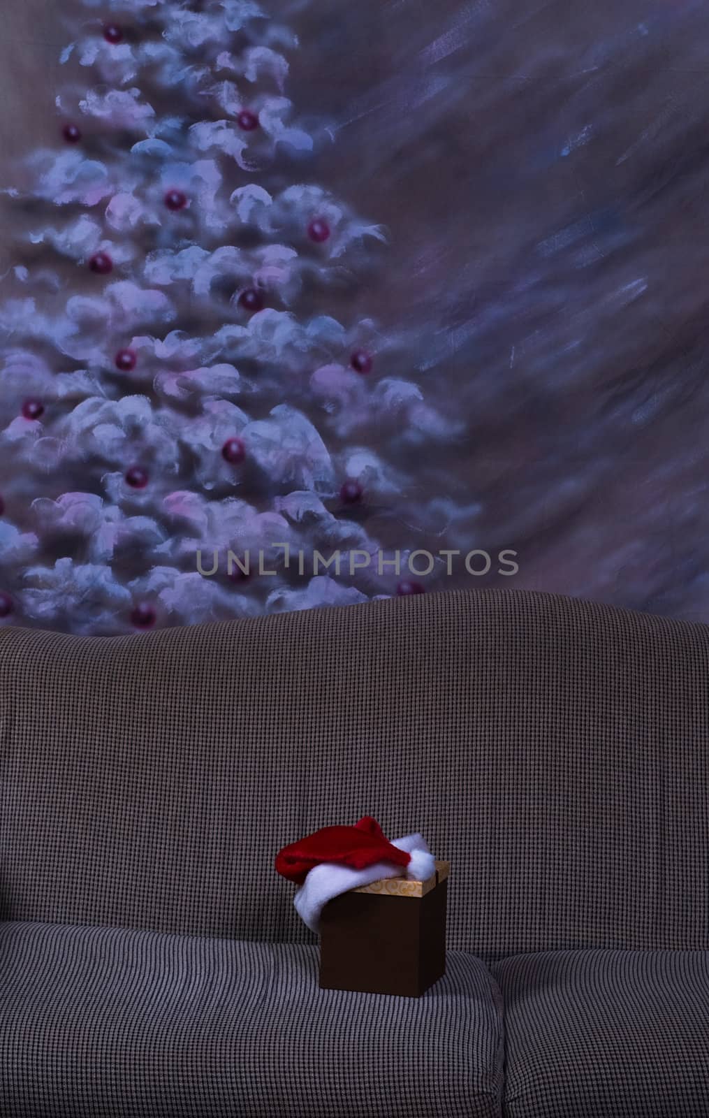 A Christmas giftbox with a santa hat on it, shot with a hue to show it is in the dark or at night