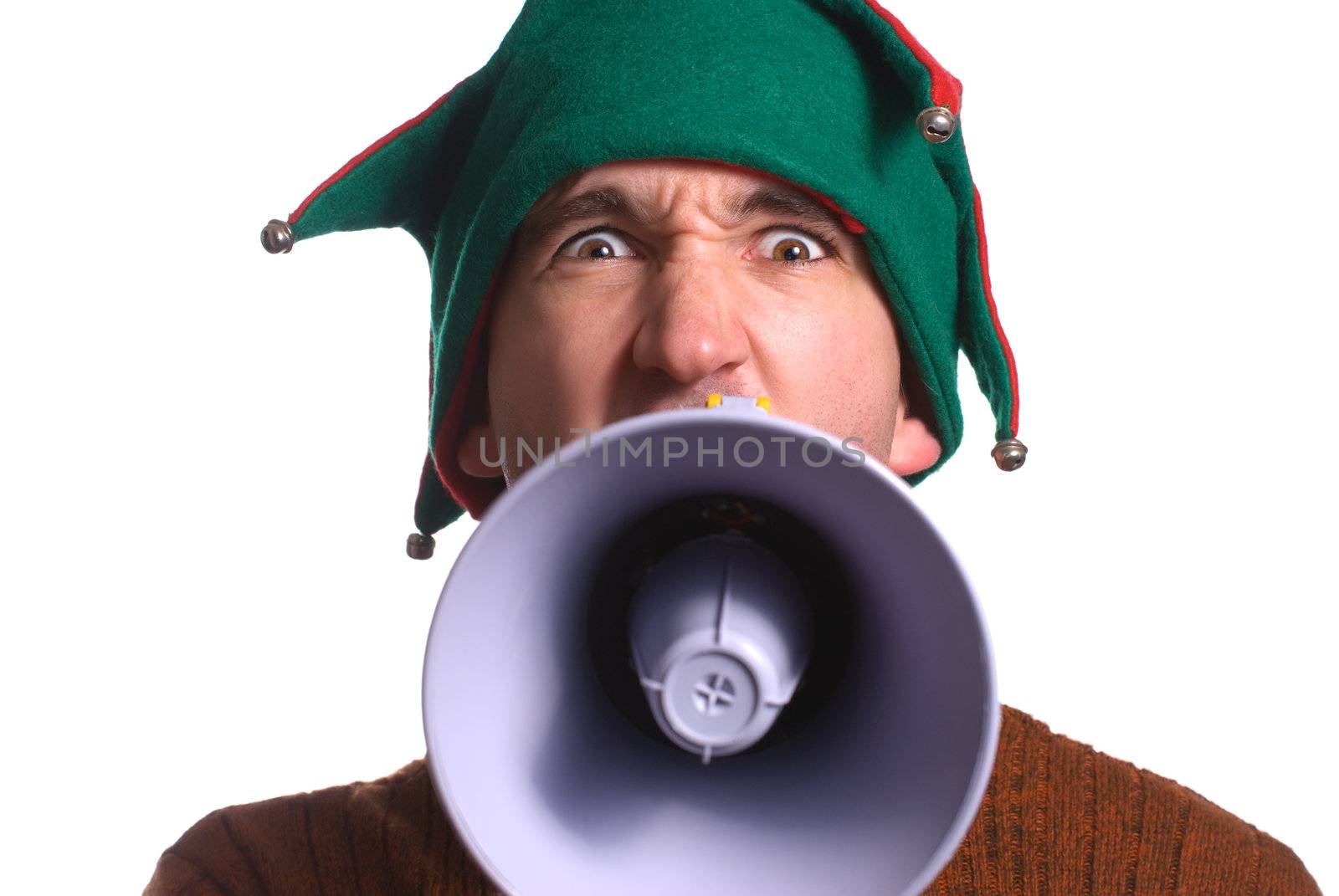 An adult Christmas elf is yelling into a megaphone and facing the camera