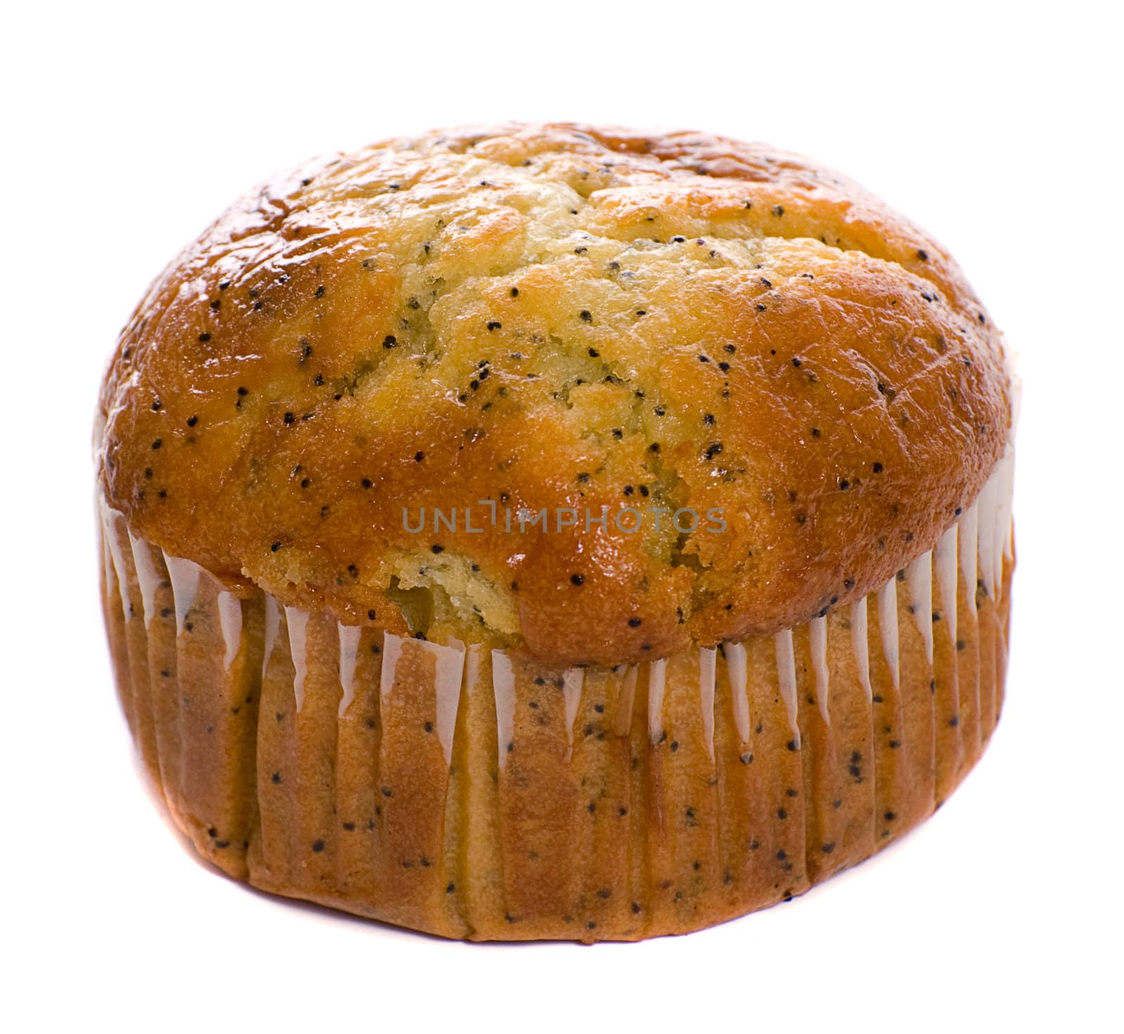 A carrot muffin with the wrapping on is isolated against a white background