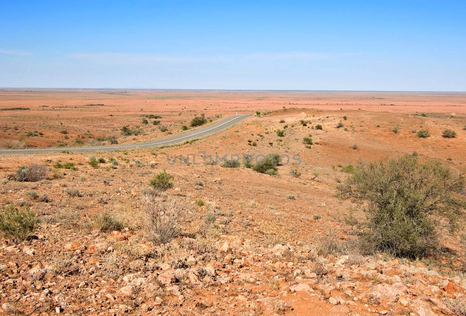 road through the beautiful but hot dry and barren desert in australian outback