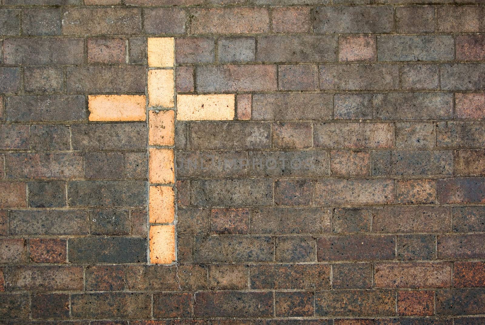cross of christ built into a brick wall by clearviewstock