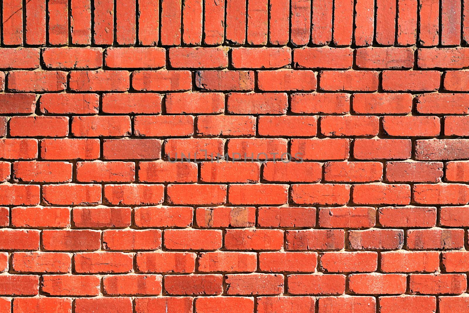 Background Texture: Red Brick Wall with Perpendicular Top Row