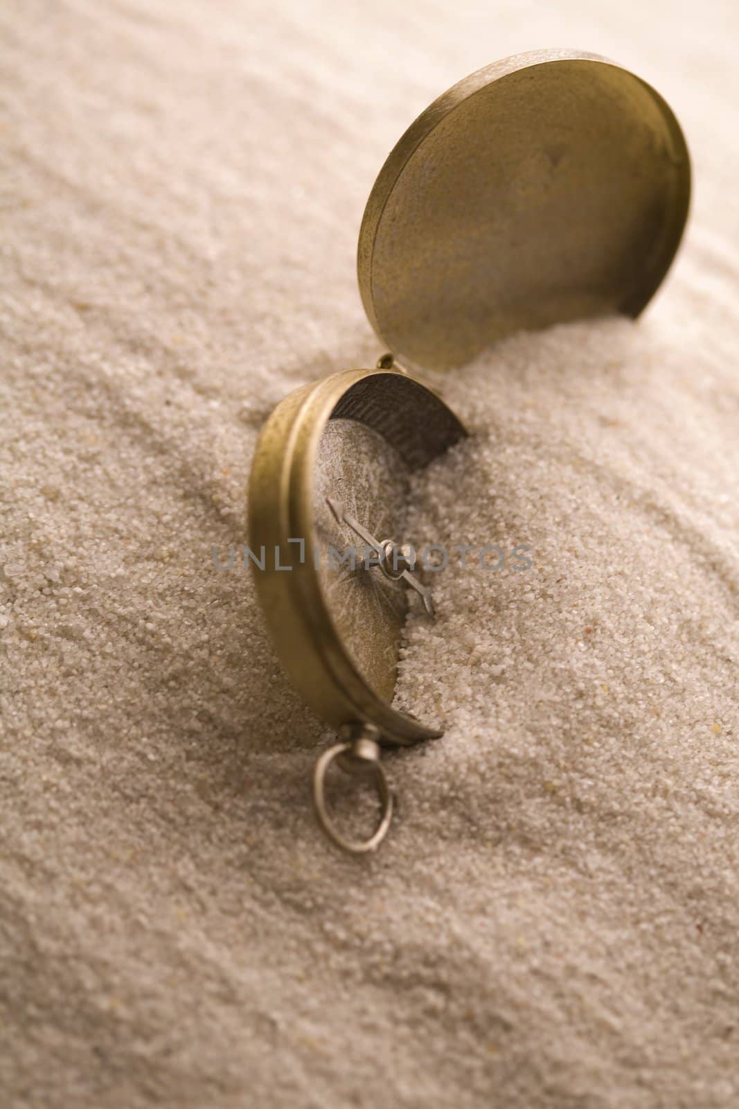 Old compass in sand by shiffti