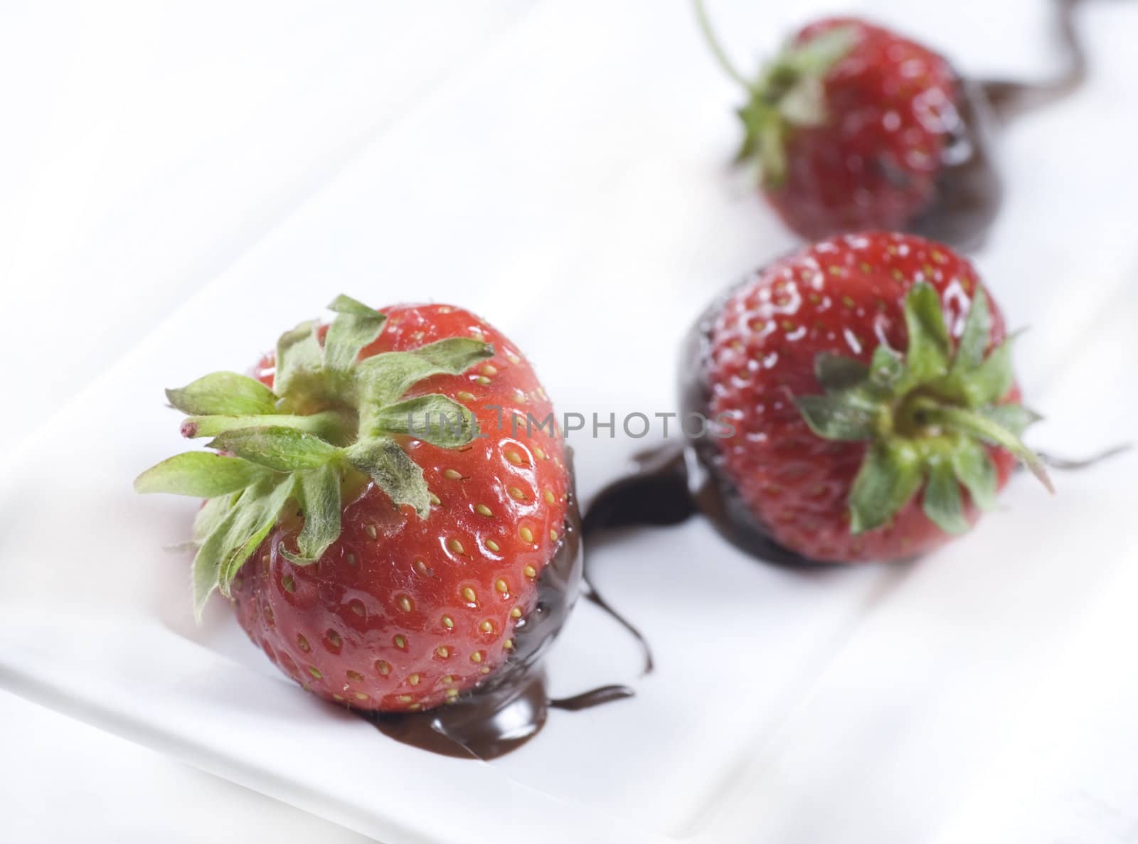 A plate of strawberries and chocolate