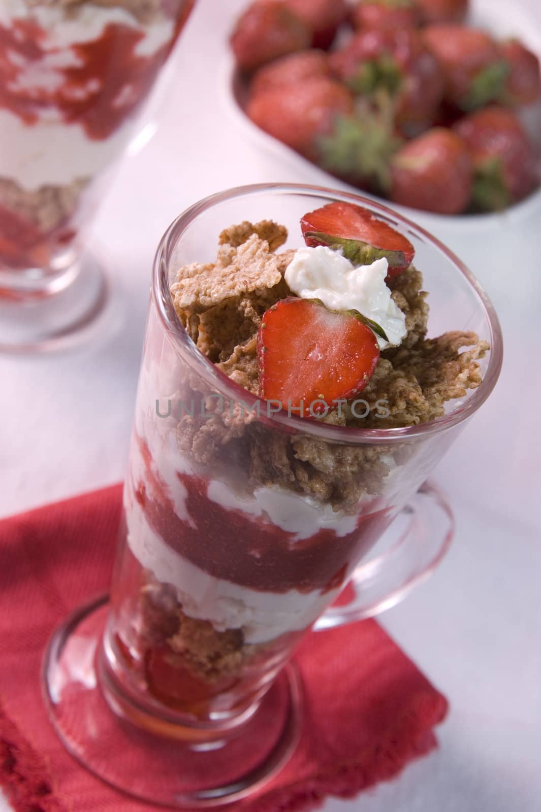 strawberry dessert with cereals, yoghurt and cream