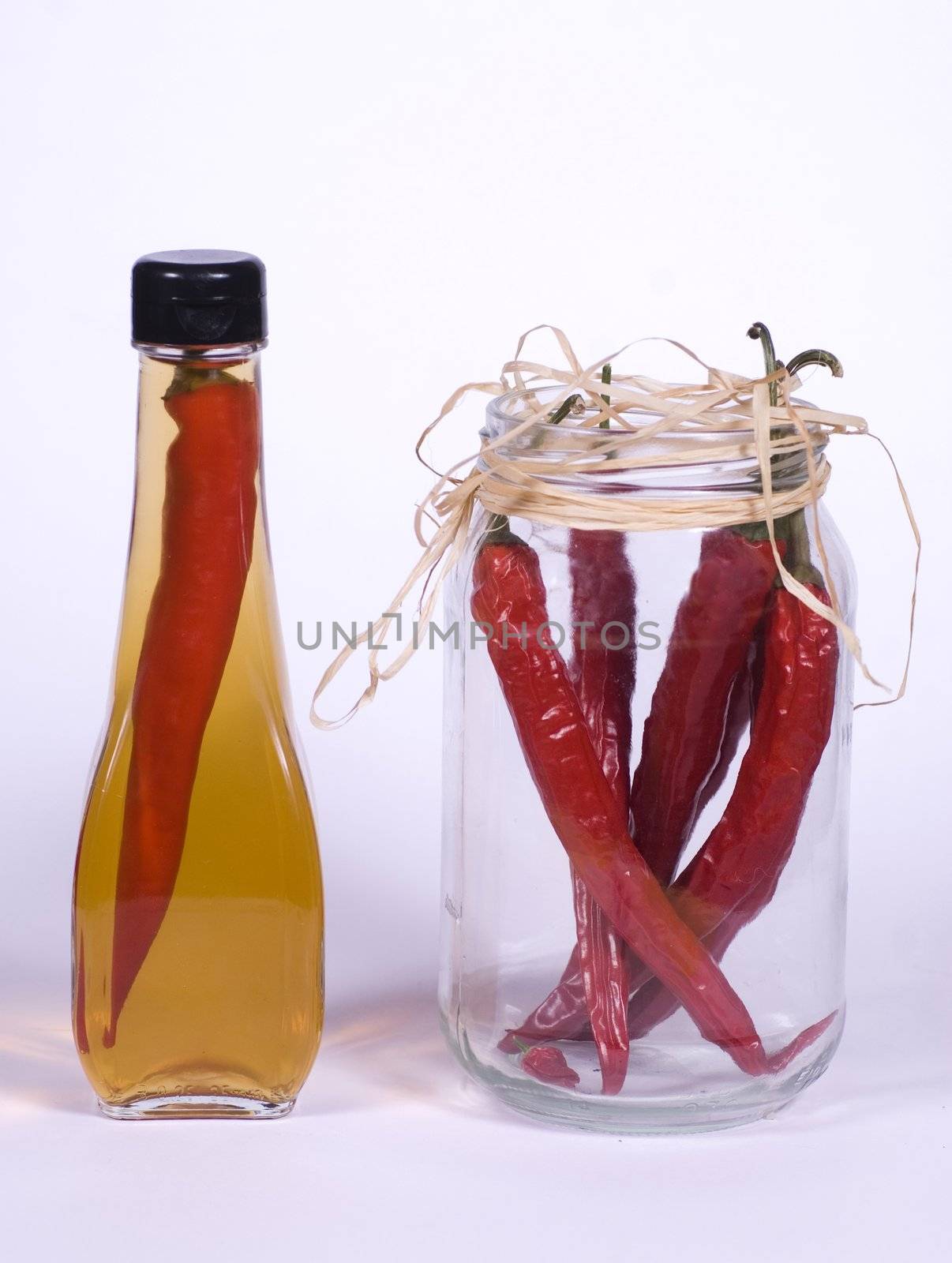 Flasks of Olive Oil and Red Chilli Peppers In Jar