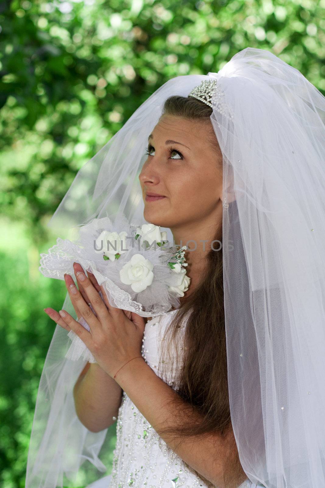 The bride with a bouquet on a green background