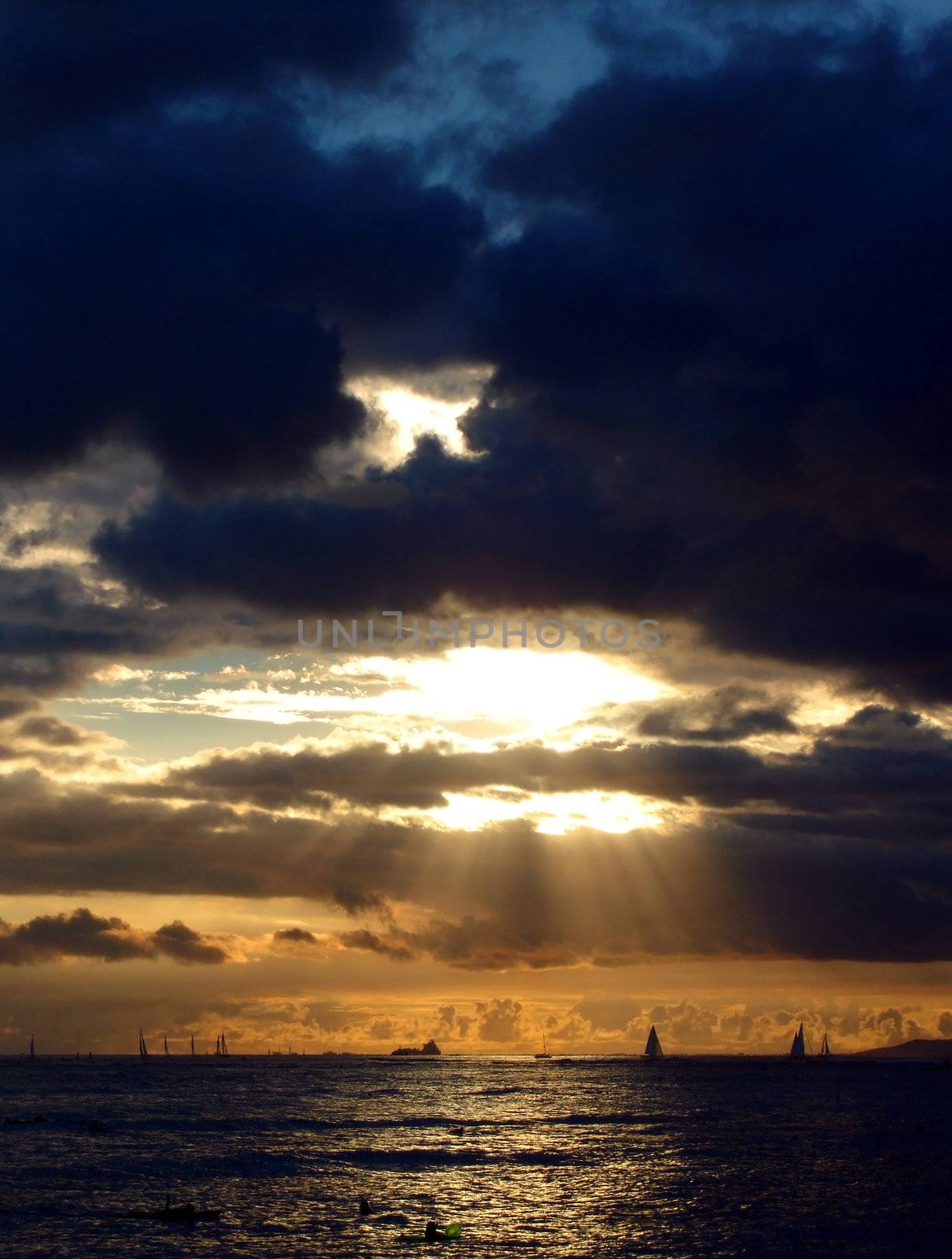 Sunset over Boats and Ships travelling to/from Honolulu Harbour, Hawaii.  Photograph taken from Waikiki Beach.