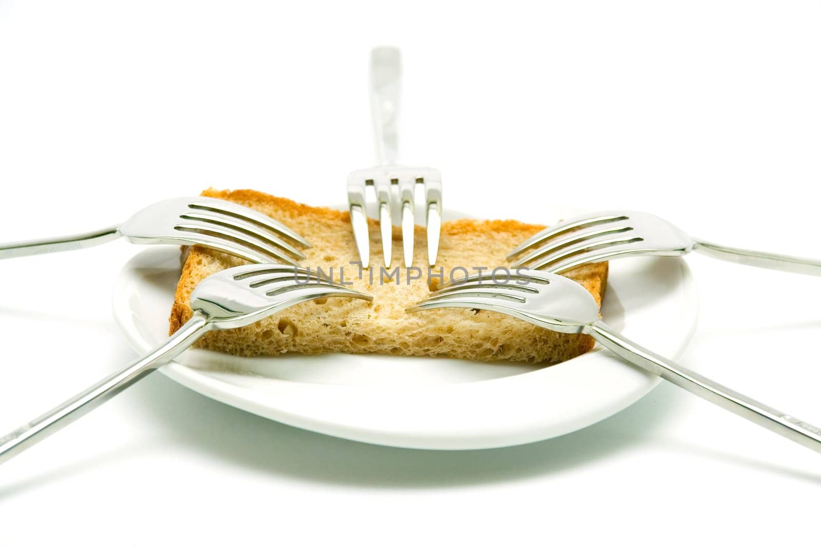 Some forks, white plateau and bread slice on a white background. 
The concept of limitation of resources. The concept  sharing between consumers.
