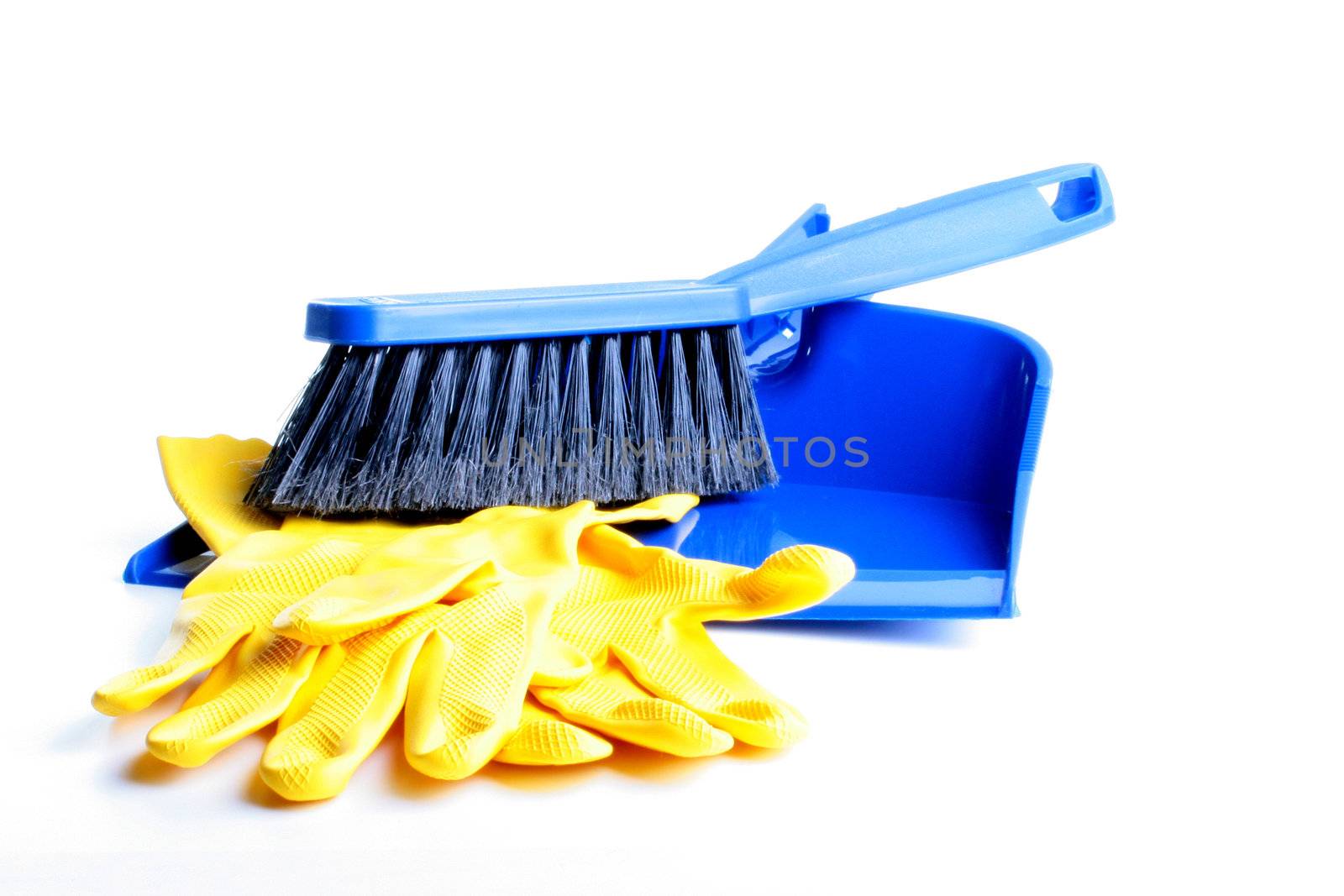 Dust-pan and brush of dark blue colour with a black bristle for dust cleaning and yellow rubber gloves on a white background.