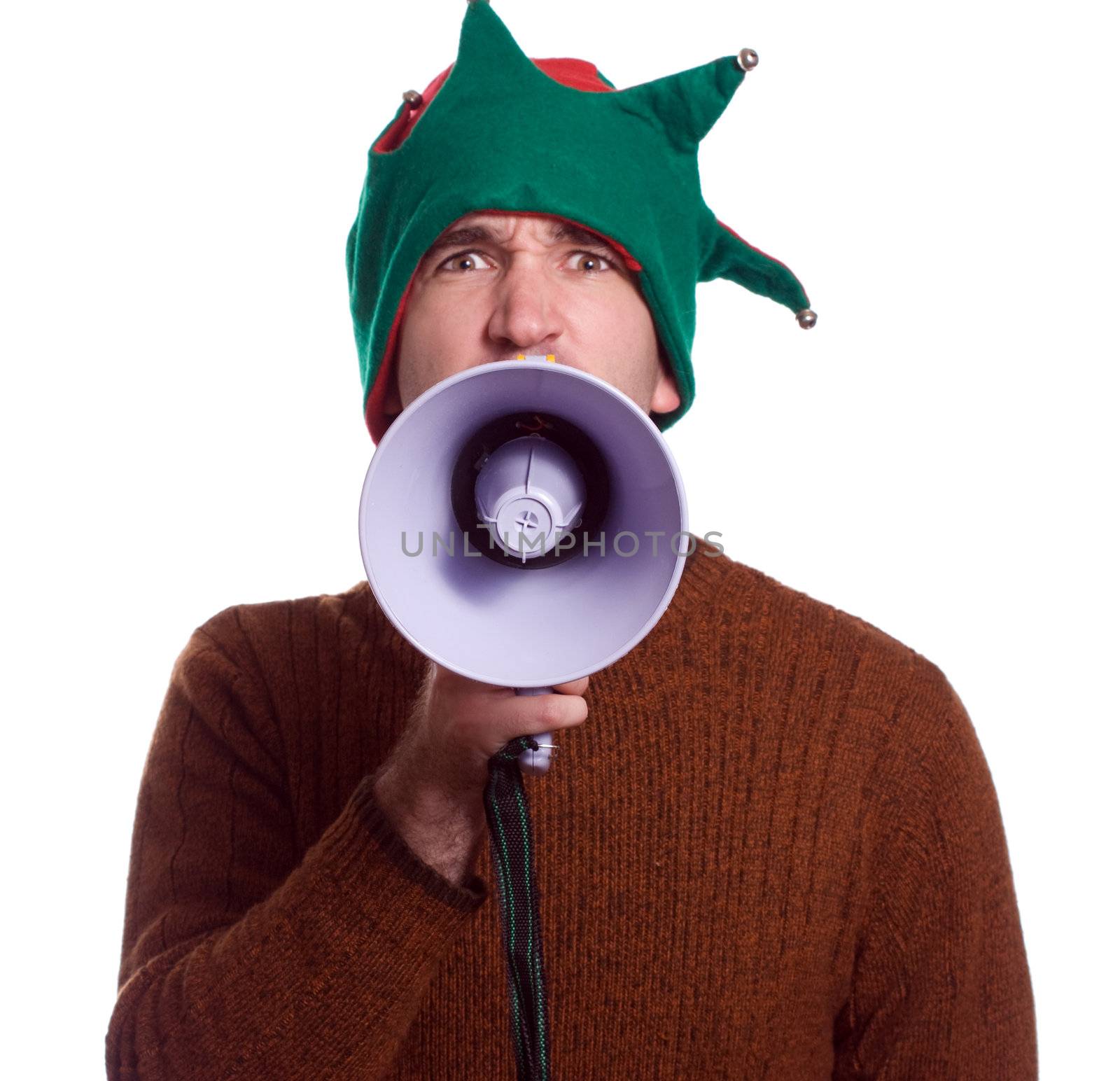An adult Christmas elf is using a megaphone to yell at the viewer and is isolated against a white background