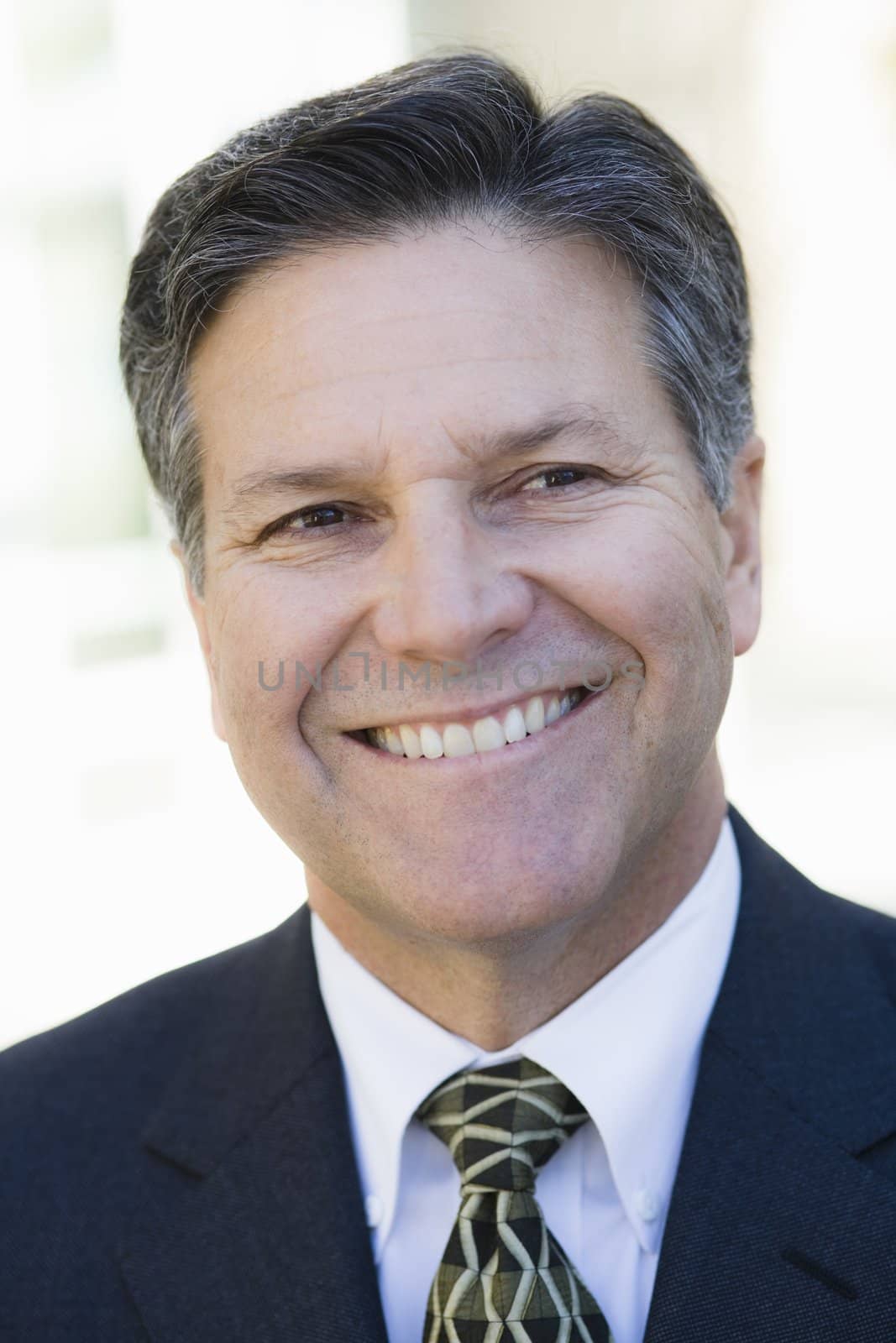 Portrait of a Smiling Businessman Looking Away From Camera