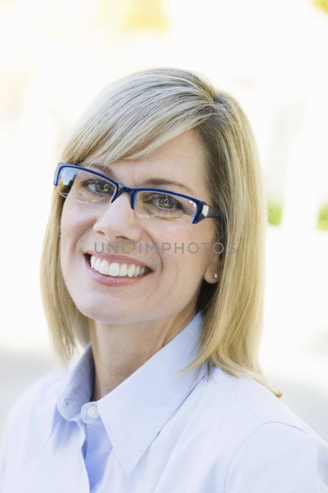 Portrait of a Pretty Blond Businesswoman Smiling To Camera