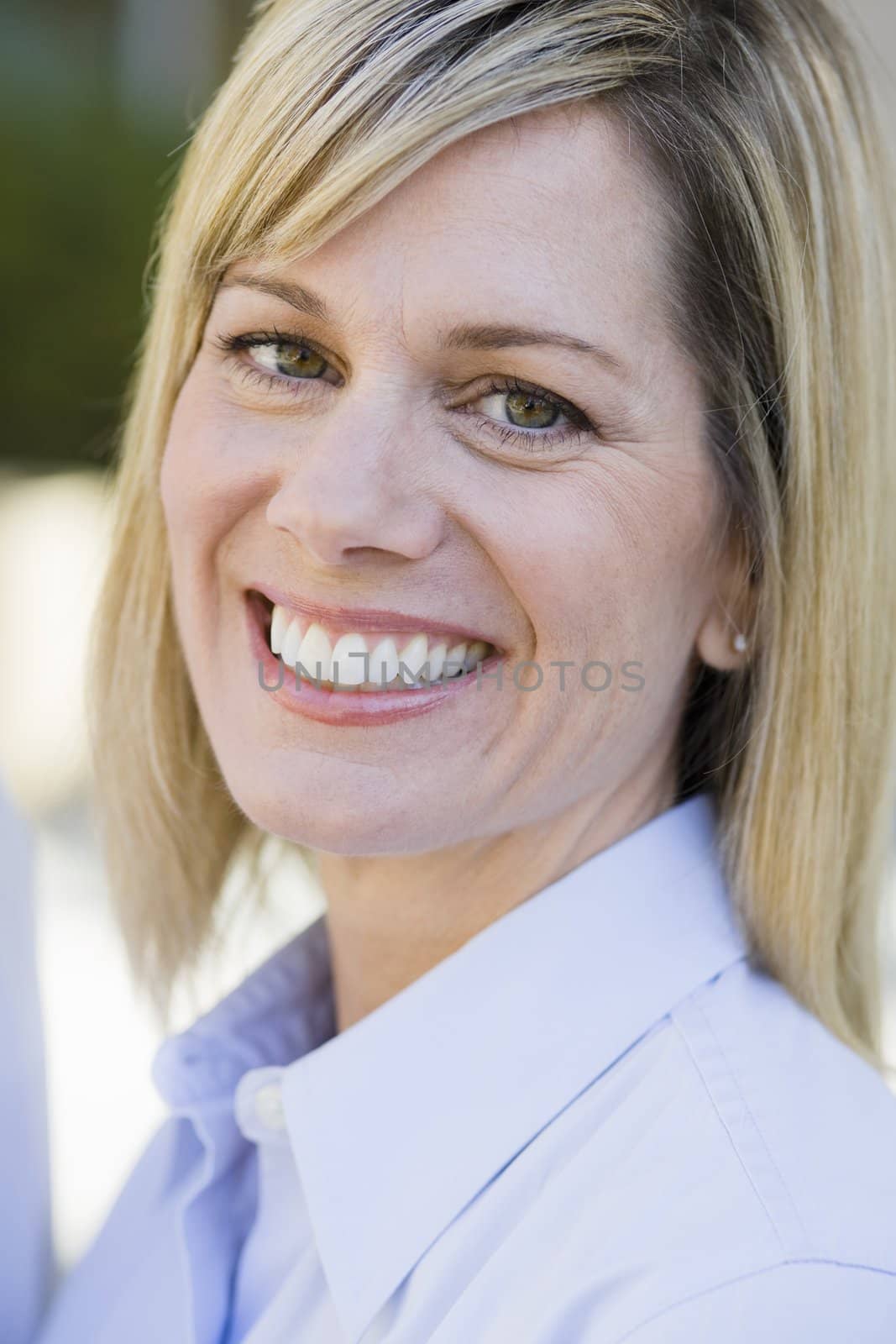 Portrait of a Pretty Blond Businesswoman Smiling To Camera