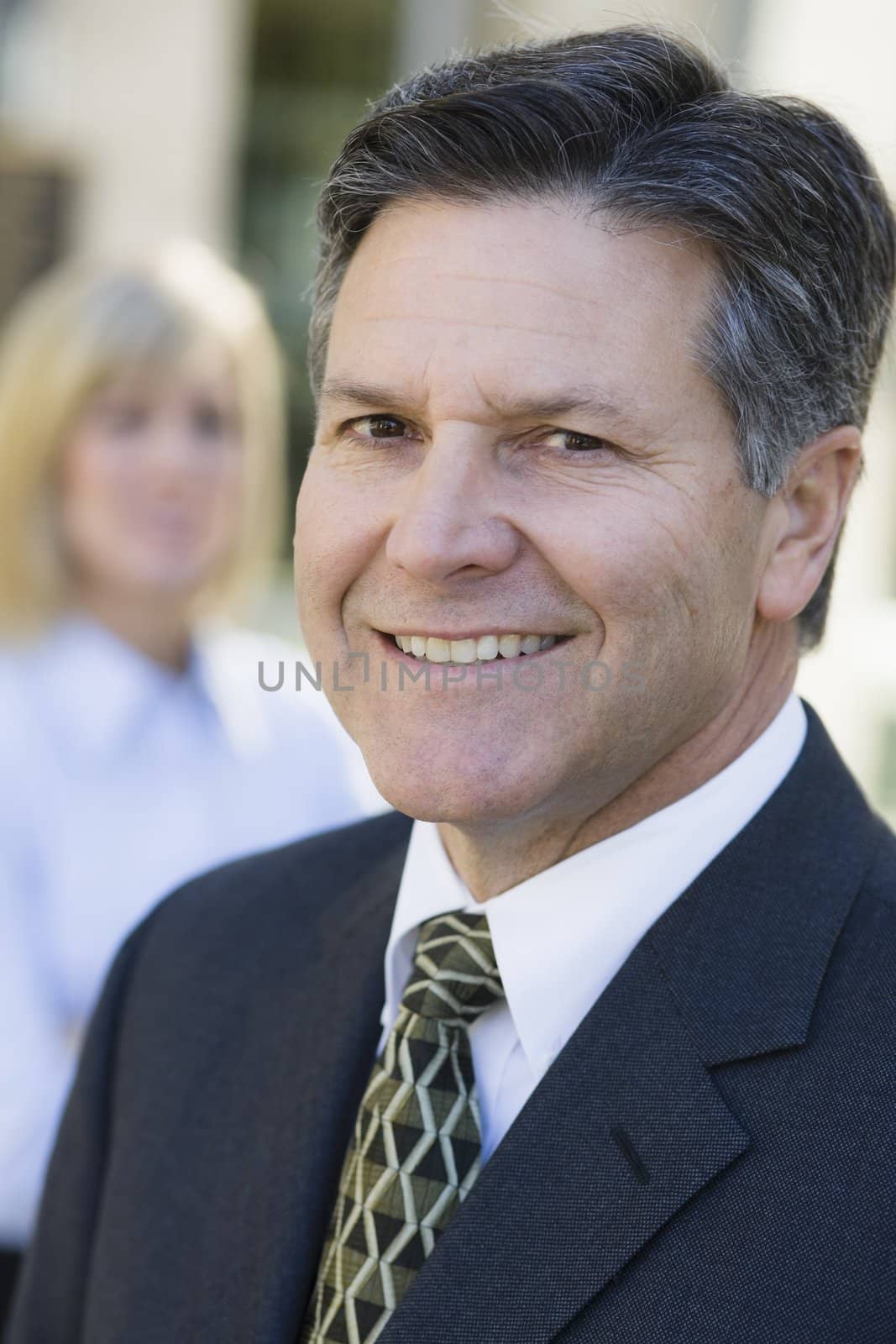 Portrait of a Smiling Businessman Standing Outdoors