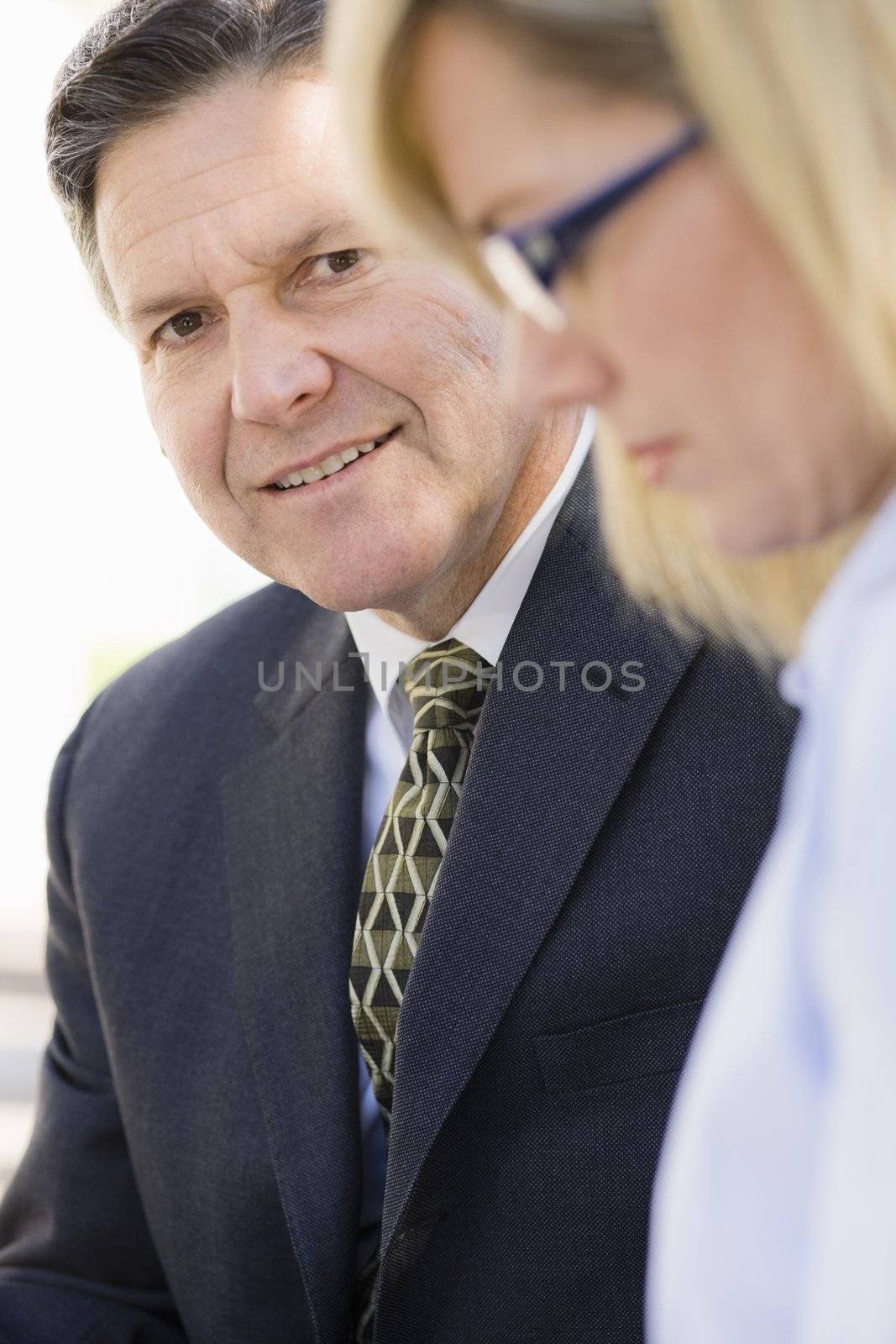 Portrait of a Smiling Businessman Looking at a Co-Worker