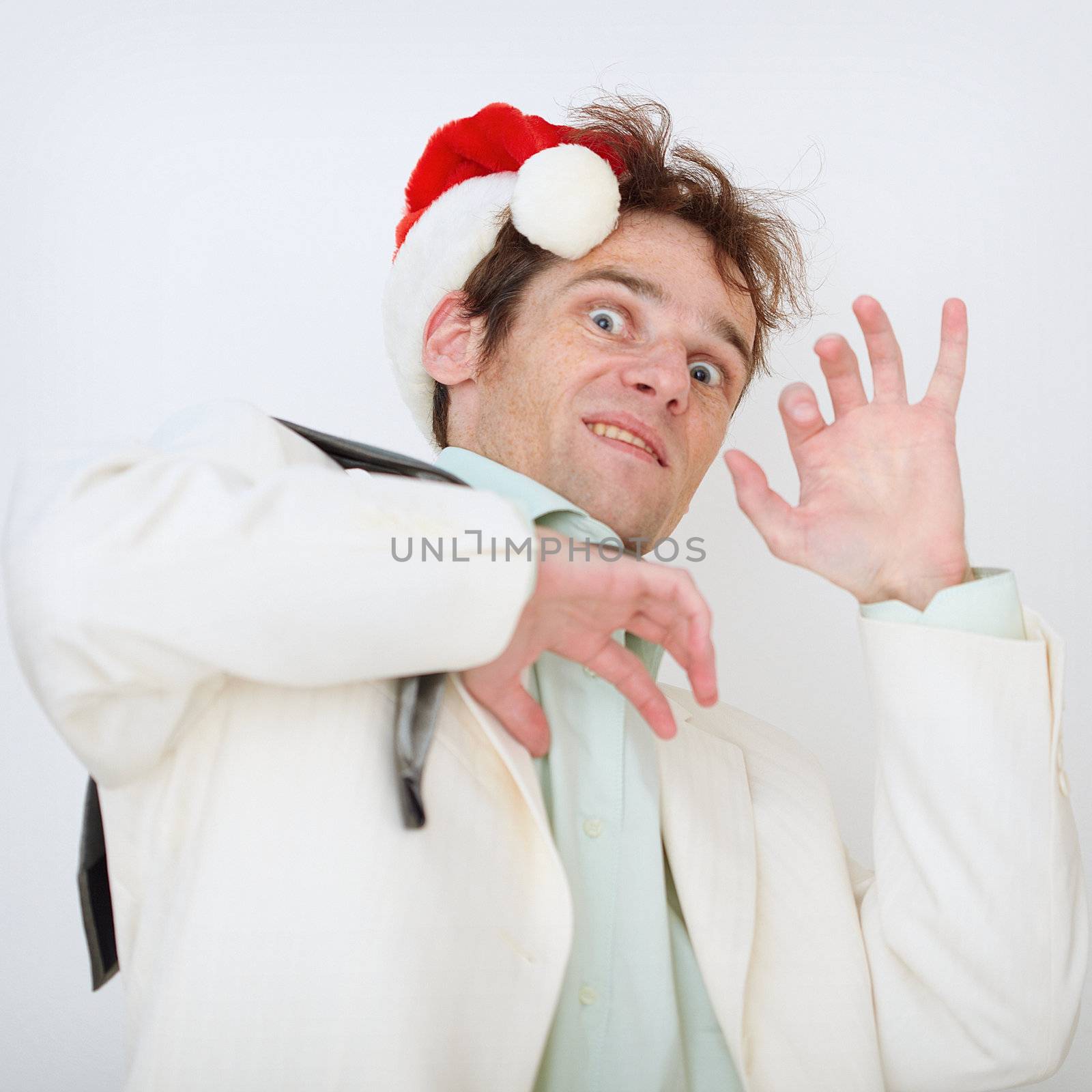 Portrait of the scared person in a New Year hat on a white background
