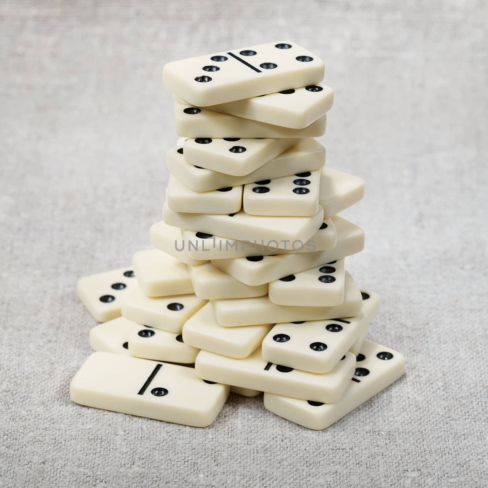 The big heap of ancient counters of dominoes against a canvas