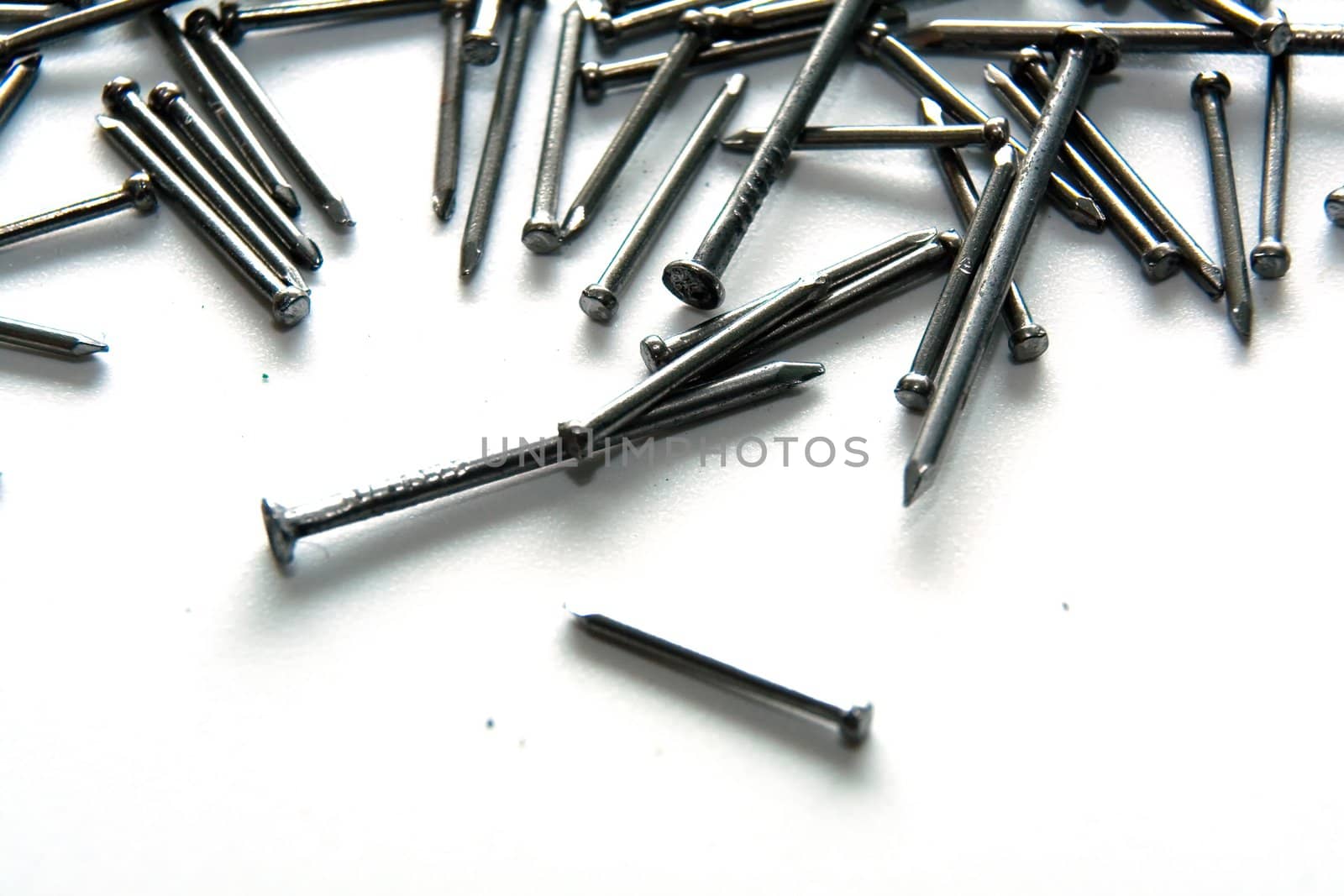 Stack of iron nails on white background