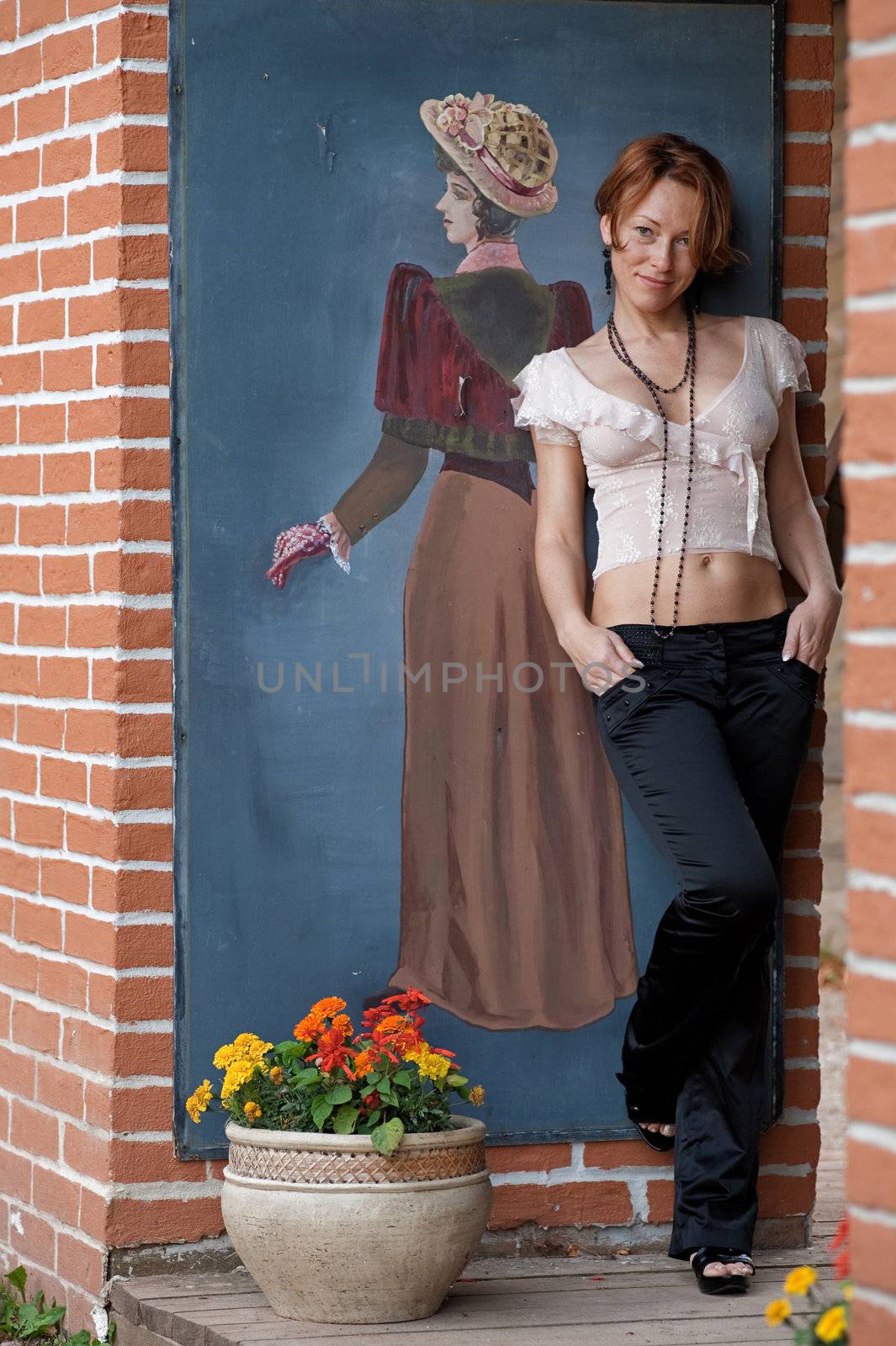 Adult women posing at the wall with retro picture