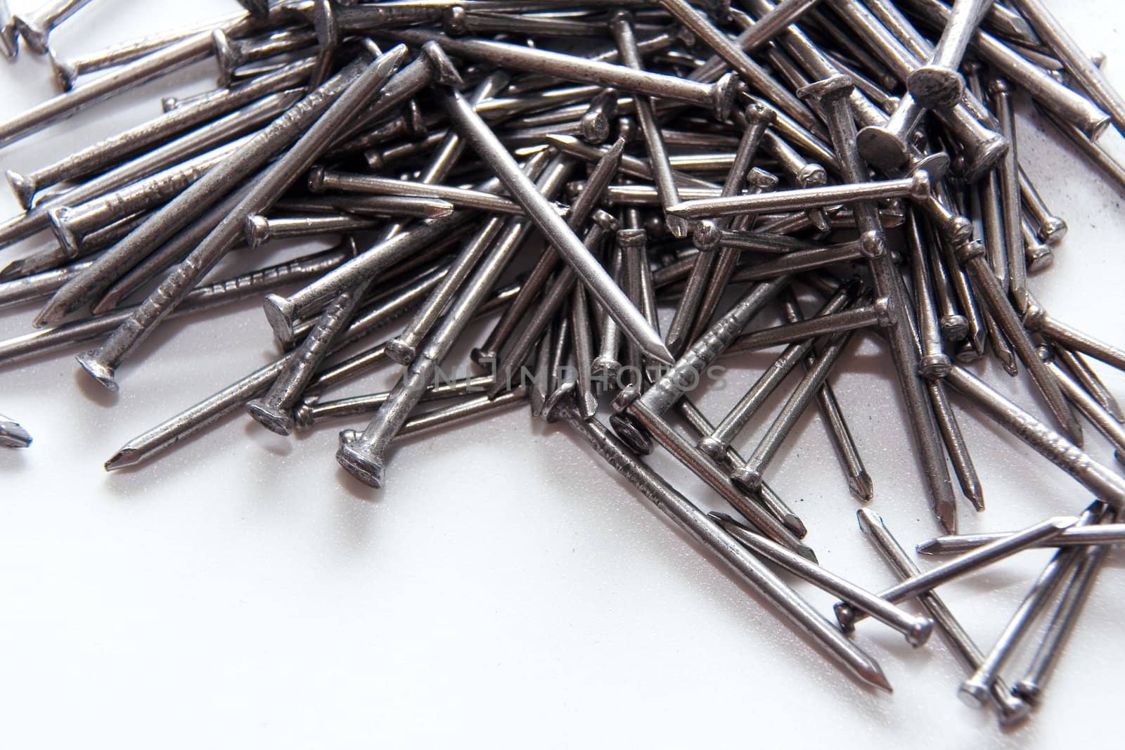 Stack of iron nails on white background