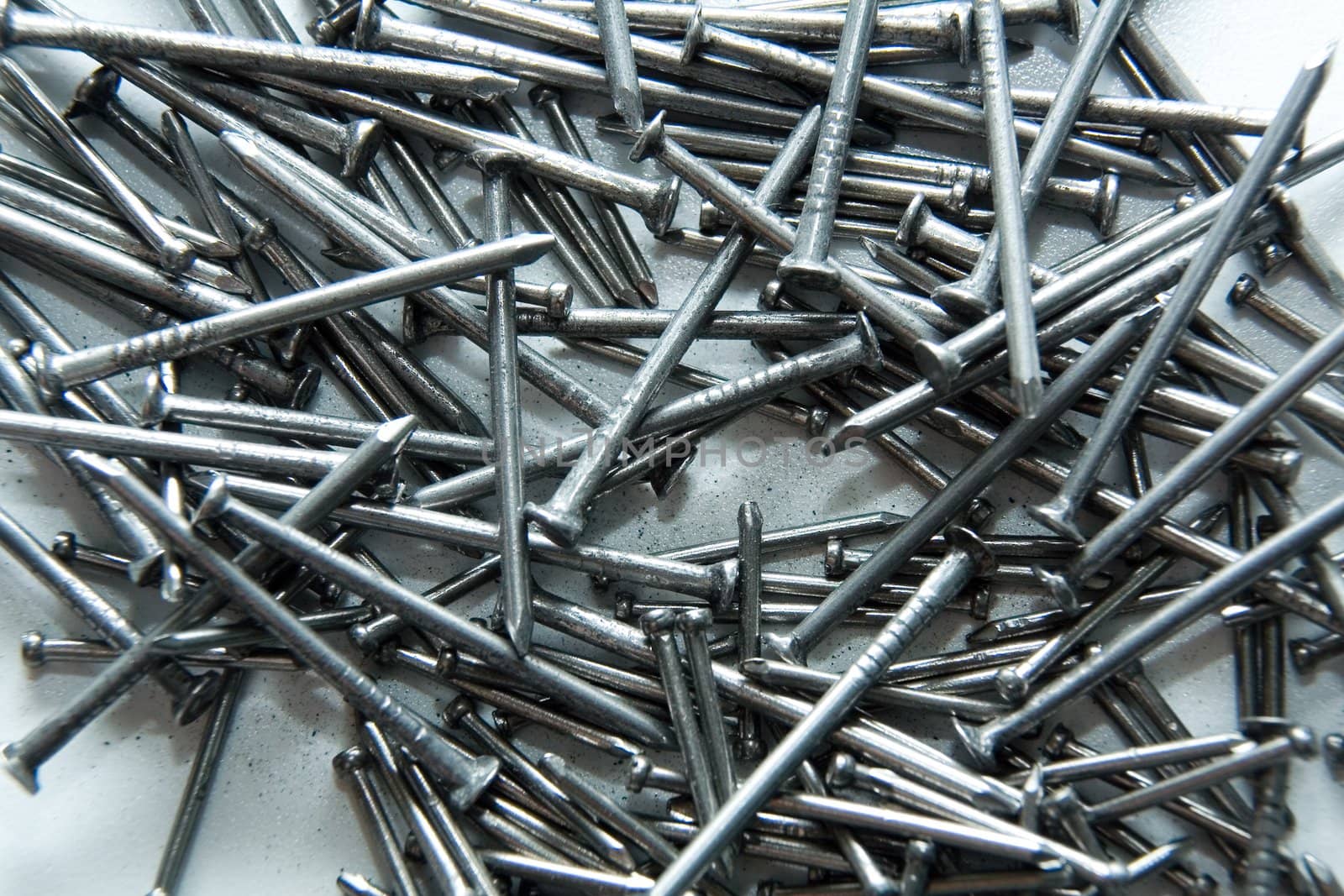 Stack of iron nails on white background