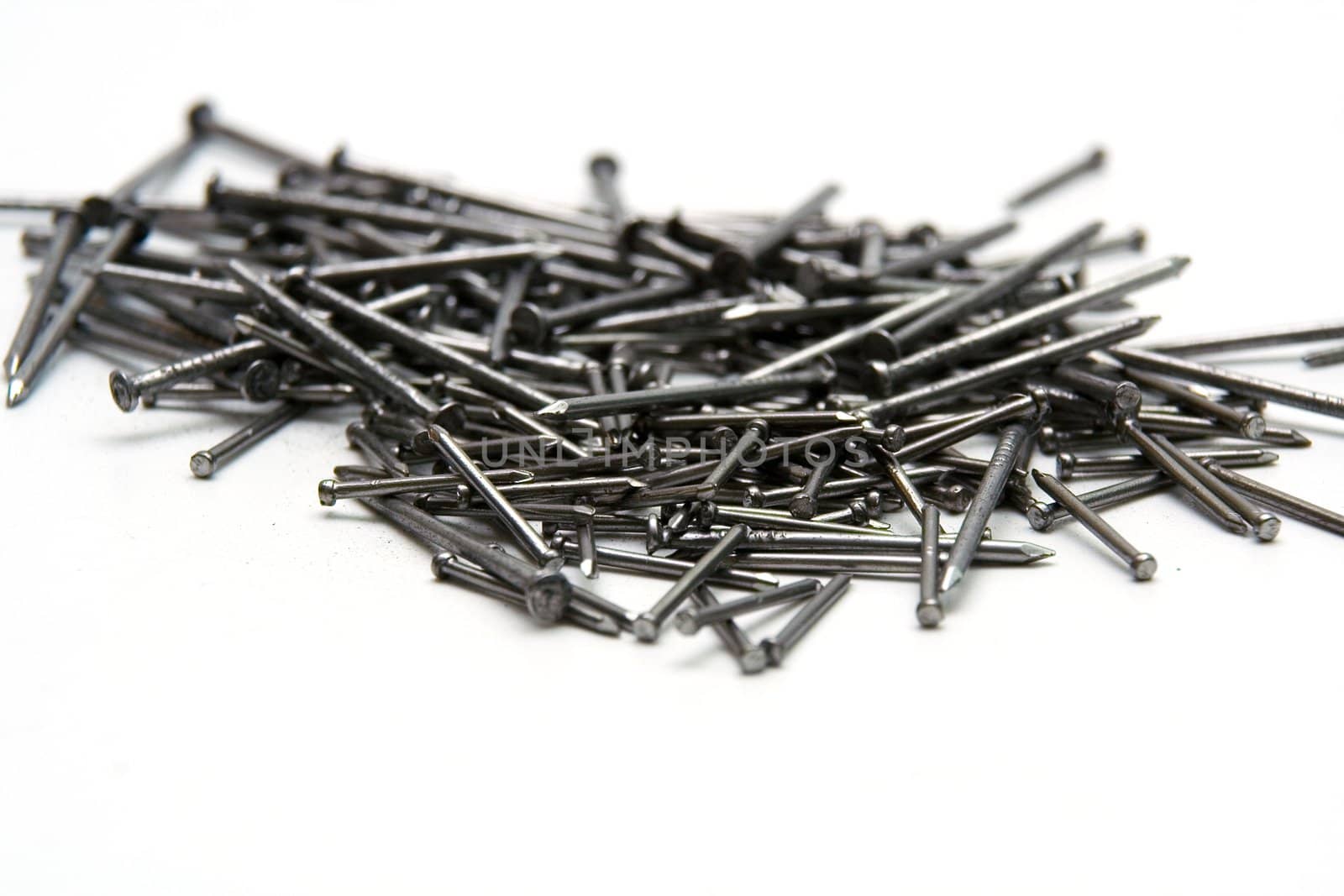 Stack of iron nails on white background