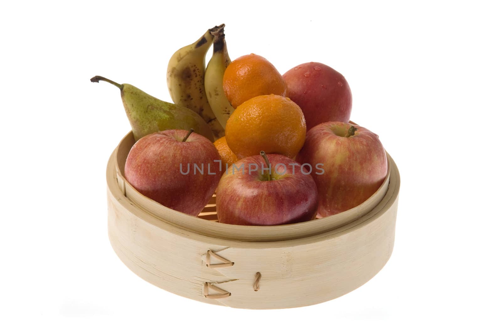 Bamboo steamer with apples, pears, tangerines and bananas,.
