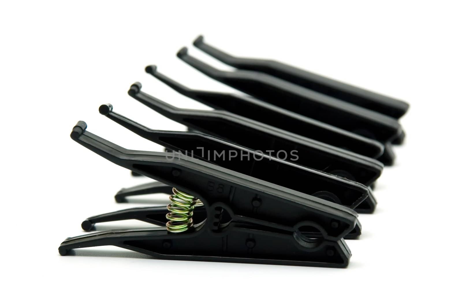 Black plastic  linen clothespins on white background