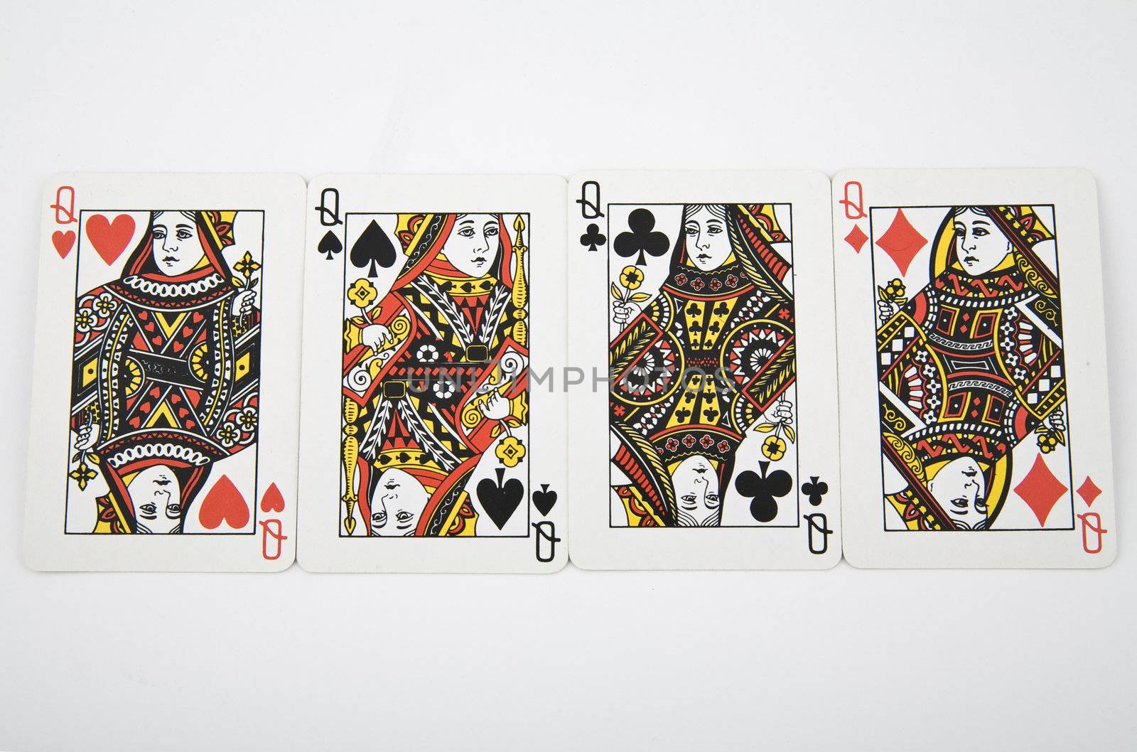 four queens - playing card on light background