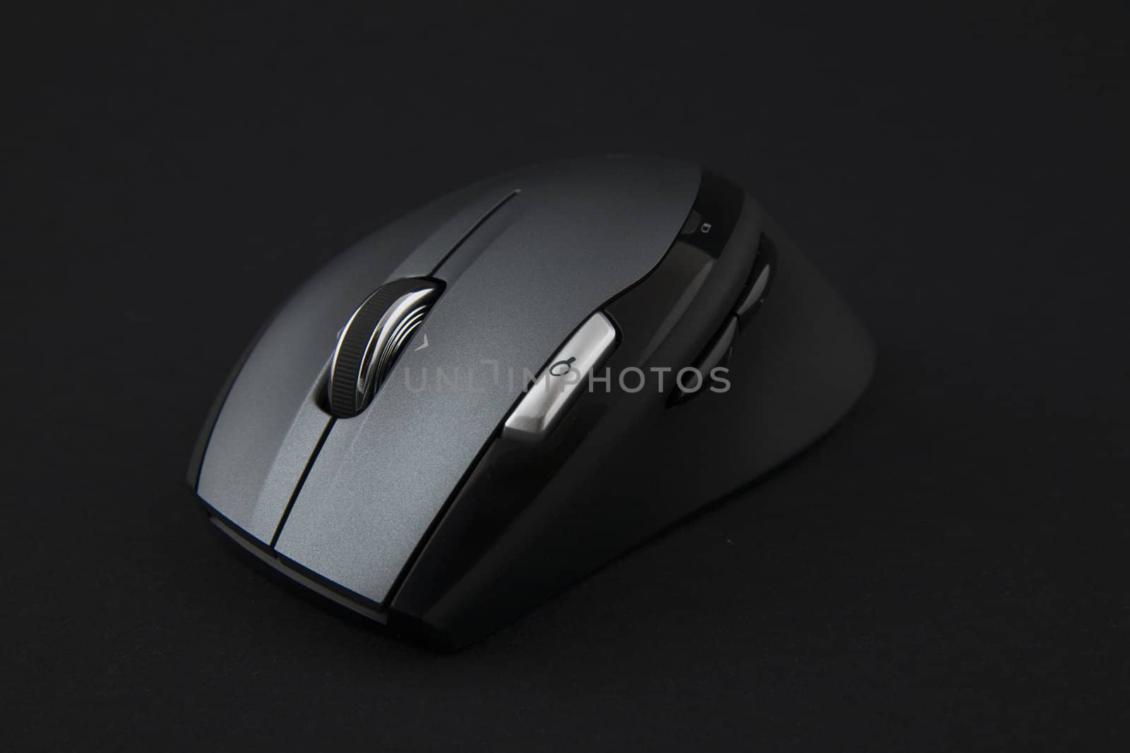 cordless computer mouse on very dark background