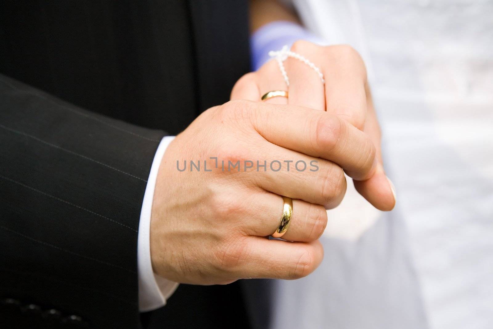 marriage ceremony - two lover's hands just after marriage ceremony