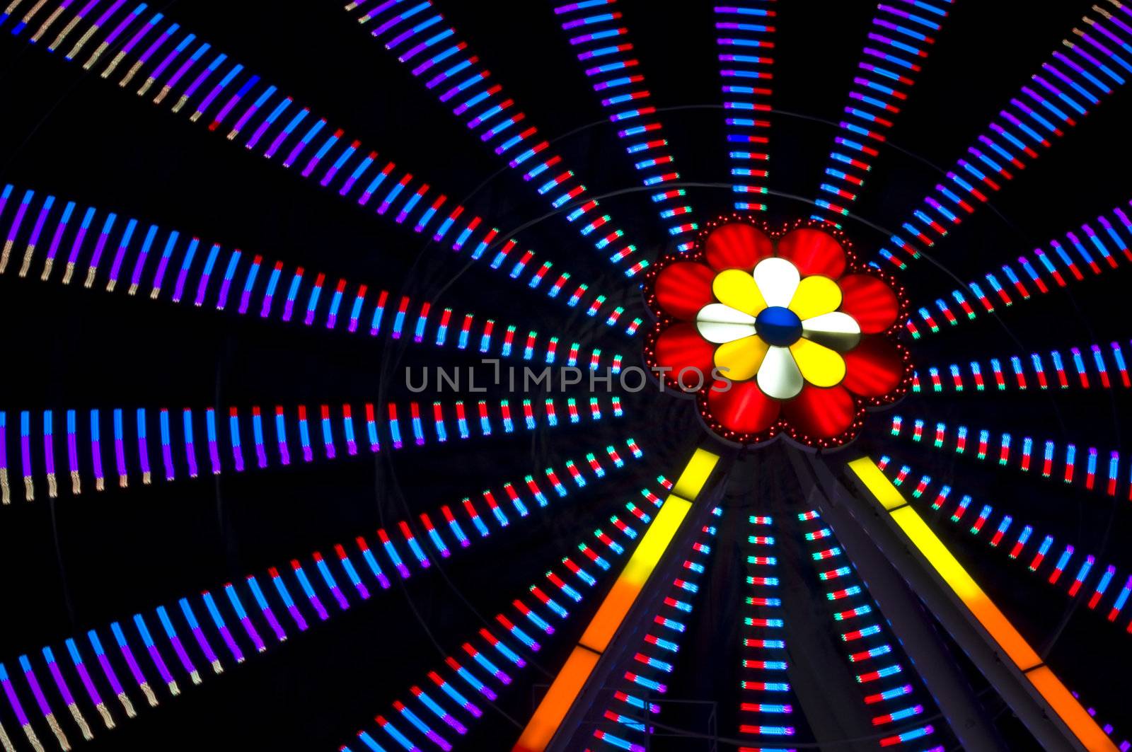 motion blur of a colorful ferris wheel at night