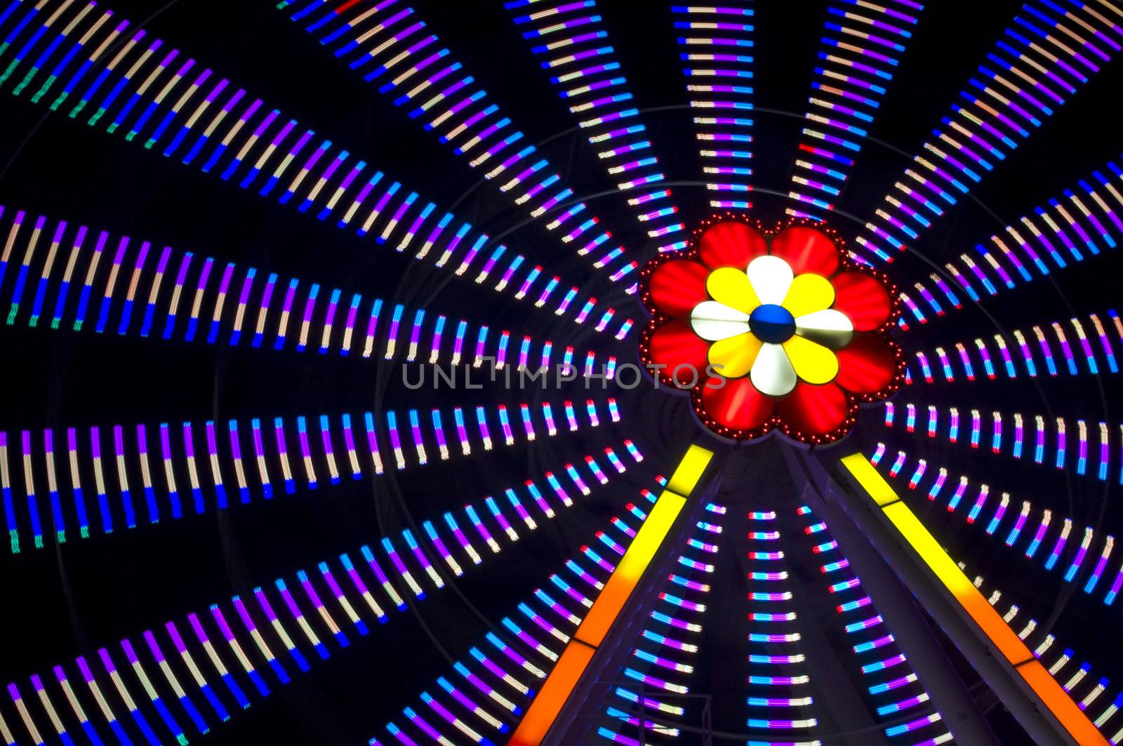 motion blur of a colorful ferris wheel at night