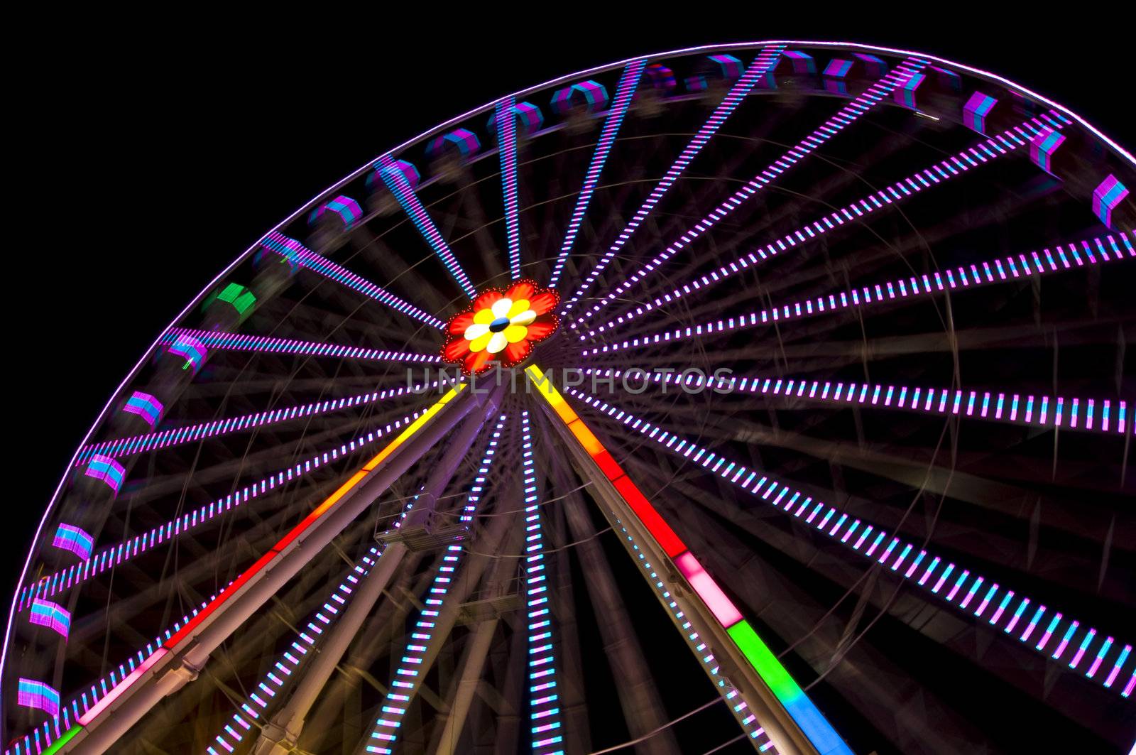 motion blur of a colorful ferris wheel at night
