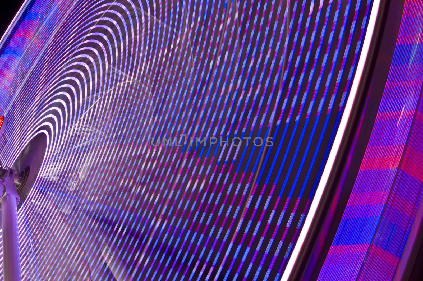 motion blur of a colorful ferris wheel at night